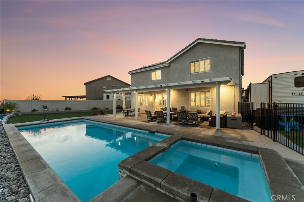 VIEWS, VIEWS, VIEWS! Enjoy breathtaking city lights and mountain views from this stunning Singleton Heights home. With 4 bedrooms, 3 bathrooms, and 2,586 sq ft of living space, this residence is only 6 years old and designed for modern living. Inside, you’ll love the open floor plan featuring luxury vinyl plank flooring downstairs, a spacious living area, and a chef’s kitchen with a large island, granite countertops, and classic subway tile backsplash. A full bedroom and bathroom downstairs add convenience, while upstairs offers a versatile loft and generous bedrooms. The backyard is truly to-die-for—perfect for entertaining or relaxing! Highlights include a sparkling pool and spa, covered patio with ceiling fans, low-maintenance artificial turf, and plenty of space for gatherings. Plus, this property is complete with paid solar, RV parking with hookups (fits up to a 42-ft travel trailer), and the bonus of NO HOA. This home checks all the boxes—views, upgrades, energy efficiency, and outdoor living at its best. Don’t miss your chance to make this dream home yours!