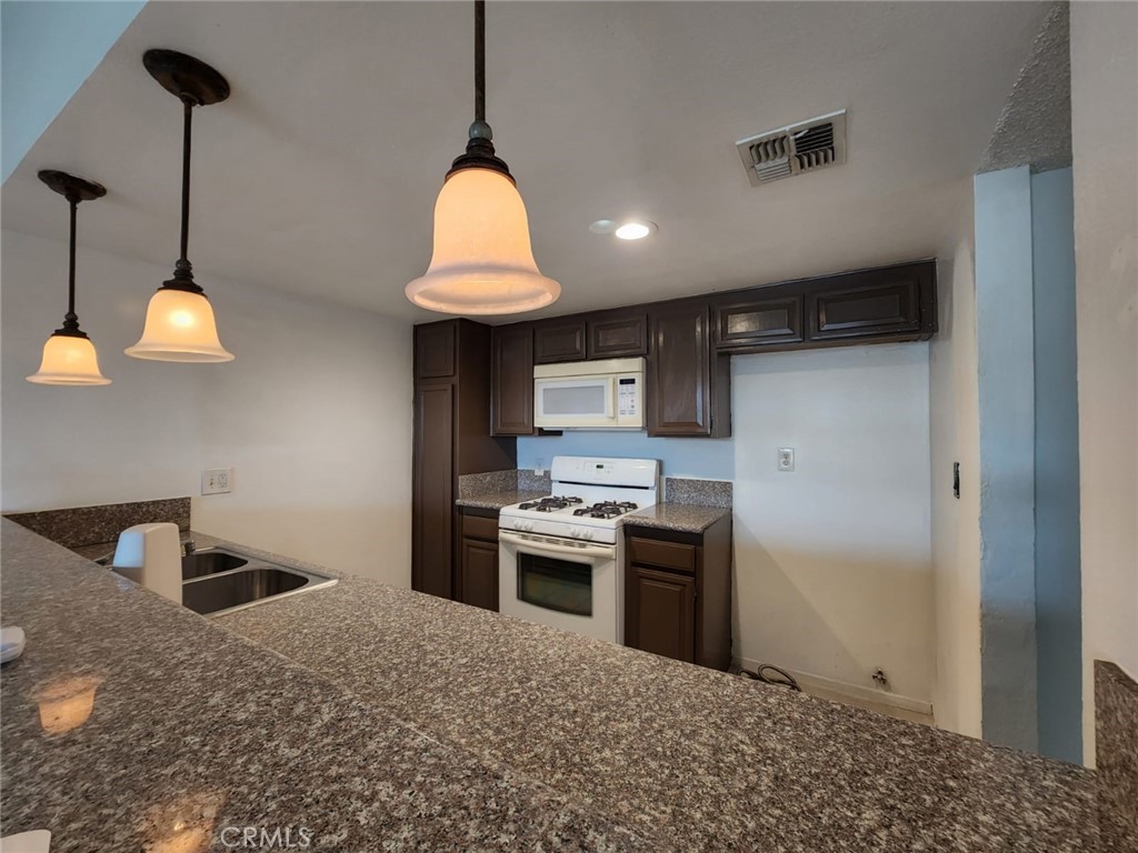 This upstairs 2-bedroom, 1-bathroom condo is perfect for first-time buyers or investors. Enjoy the convenience of an in-unit washer and dryer, along with an additional private storage unit located in the parking area behind the building. Ideally situated near a variety of restaurants, shopping centers, and supermarkets, this condo offers both comfort and convenience.