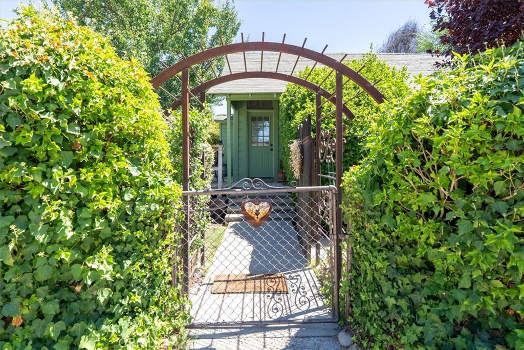 Nestled in the heart of Paso Robles’ coveted Westside, this charming 1916 home is located on iconic Vine Street just minutes from downtown. Offering two bedrooms and one bathroom, the residence features high ceilings adorned with transom windows that fill the space with natural light. A 2010 YORK conventional heating and air system ensures year-round comfort. Situated on a desirable corner lot, the property boasts a spacious and private backyard with a large, newer covered patio—perfect for relaxing or entertaining. The lush perimeter of vines and hedges creates a peaceful, secluded setting, complemented by a custom entry gate. The kitchen has a wood-style countertop some newer cabinetry and room for a breakfast nook. The bathroom includes a classic clawfoot bathtub and a low-flow toilet, blending vintage charm with modern efficiency. An impressive basement provides generous extra storage and there is an indoor laundry room, between the kitchen and patio. While the home offers timeless appeal, it is in need of cosmetic updates and front deck replacement and is being sold as-is. This is a rare opportunity to own a character-rich property in one of Paso Robles’ most sought-after neighborhoods.