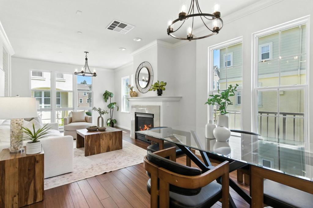 Welcome to 407 Timor Ter, a stunning and rare end-unit townhome in the prestigious Parkside Villas at Tasman Crossing. Flooded with natural light from additional end-unit windows, this luxurious residence has been thoughtfully upgraded throughout. Endless owner upgrades throughout, such as upgraded lighting fixtures, California Closets, top of the line counters, appliances, elegant moulding, hardwood flrs, an extra Bonus Rm w/ crawl space storage & more! Open Living Rm w/Gas fireplace and floor to ceiling windows. Separate Family Rm off of the Kitchen makes it easy to entertain while cooking. The Gourmet Kitchen is a chef's dream, equipped w/ premium countertops, abundant cabinetry, a powerful exhaust hood, and top-tier appliances. Powder Rm on main level. Extra Bonus Rm downstairs, great for office / gym. Oversized Owners Suite w/ dual sinks, tub, shower & custom WIC. Spacious 2nd & 3rd beds also located upstairs w/ upgraded hallway bath. Laundry Area and additional Loft Area upstairs, perfect for evening reading. Short walk to Seven Seas Park, VTA, Grocery & coffee! Short drive to newly built Downtown Sunnyvale w/loads of dining, shopping & entertainment! Near 101, 237, 85! Minutes from major corporations such as Apple, Google, Nvidia, Meta, Microsoft & Amazon. Don't miss out!