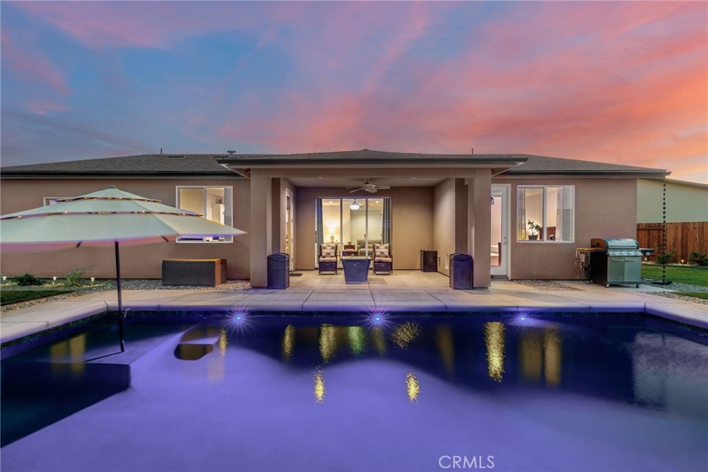From the moment you enter this home situated on a generous quarter-acre cul-de-sac lot, you’ll notice luxury throughout this 4B/2B split wing plan starting w/ vinyl plank flooring throughout. The chef’s kitchen is outfitted with premium Whirlpool built-in appliances, including double ovens, sleek quartz countertops, & oversized island perfect for entertaining. Bathrooms feature elegant Bianco polished marble, while the laundry rm is complete w/utility sink & double-door storage closet, wired with an outlet for convenient charging of your cleaning tools. The open-concept great rm seamlessly connects to the outdoors through a stunning 9-foot glass pocket patio door, creating a true indoor-outdoor living experience. Relax beside the sparkling pool, enhanced w/ built-in LED lighting & solar umbrella for shaded lounging. Two expansive yard areas feature private seating nooks tucked in each corner. Enjoy outdoor cooking w/ built-in gas line & concrete pad ready for your custom grill.
