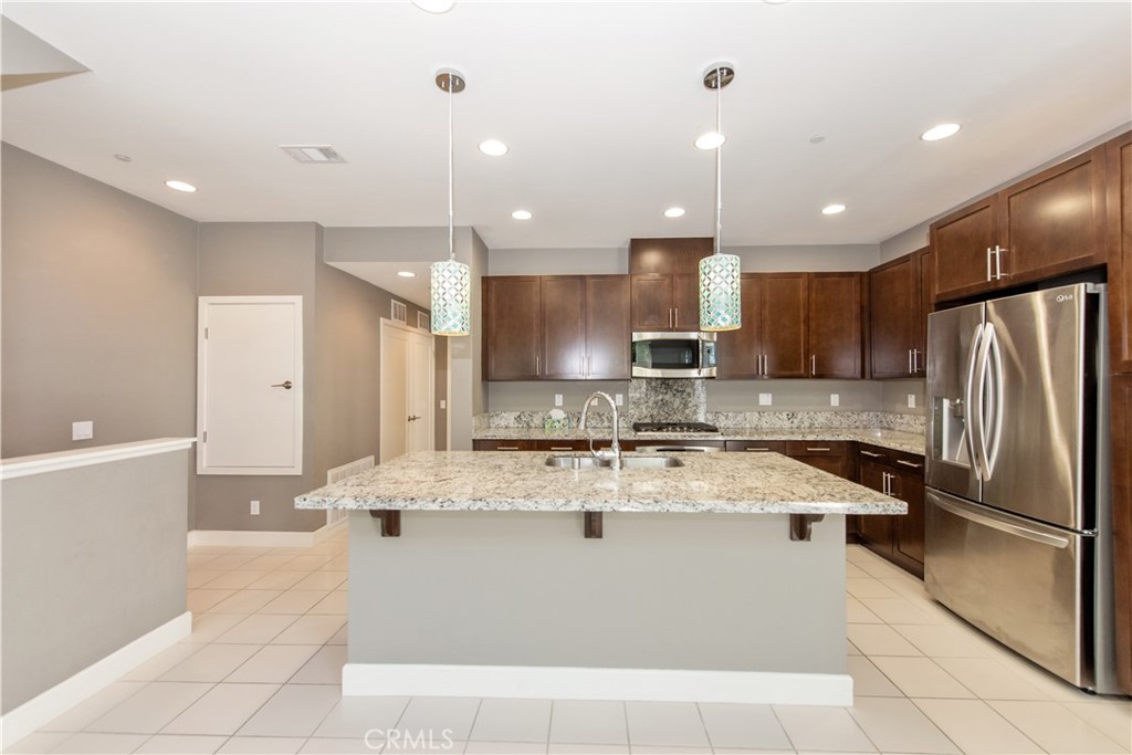 Presenting a sophisticated townhouse-style residence in Irvine's coveted Financial District at 41 Soho. This contemporary home features 3 spacious bedrooms and 3 fully renovated spa-quality bathrooms, showcasing an open-concept design with high ceilings, abundant natural light, and premium finishes throughout. The gourmet kitchen impresses with stainless steel appliances, sleek cabinetry, a custom backsplash, and ample quartz counter space, while a versatile office/loft provides flexible living space. Enjoy enhanced privacy with no units above or below, plus direct access from the 2-car side-by-side garage. Residents gain exclusive access to Central Park West’s resort-style amenities including two swimming pools, a state-of-the-art fitness center, yoga studio, outdoor spas, clubhouse with fireplace lounge, catering kitchen, BBQ areas, pickleball/sports courts, and landscaped parks. Its prime location offers easy access to high-end dining at Diamond Jamboree, premier shopping at Fashion Island and South Coast Plaza, UCI, John Wayne Airport, and pristine Orange County beaches, delivering resort-inspired living in Irvine’s premier community.