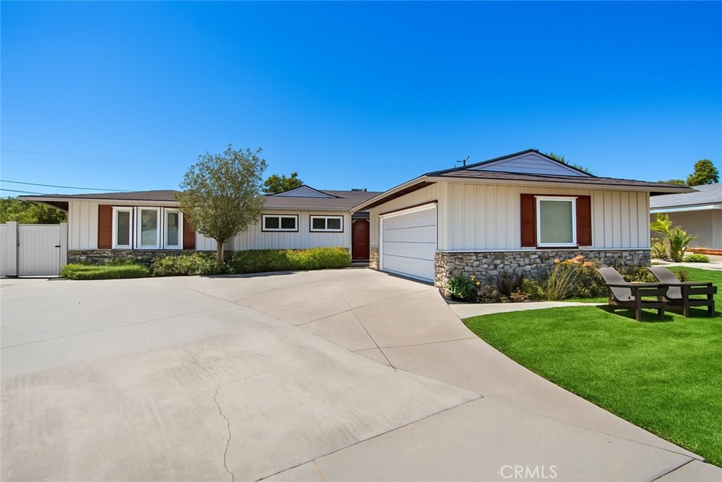 Located at the end of a highly coveted horseshoe street in Eastside Costa Mesa, this expanded single-level residence offers a rare blend of space, style, and turnkey living in one of the neighborhood’s most desirable pockets. With its wide frontage and spacious layout, the property exudes a sense of openness and privacy that’s hard to come by in this sought-after enclave.
Hardly a window has been left untouched in this thoughtfully renovated home, where timeless design meets modern comfort. Inside, the floor plan flows seamlessly from the formal living room—bathed in natural light—to a beautifully updated kitchen featuring a large center island with barstool seating, granite countertops, gas range, and custom cabinetry. The kitchen opens to the backyard, making indoor-outdoor living effortless.
The home features 3 bedrooms and 2.5 bathrooms, including a spacious bonus room with vaulted ceilings, skylights, and a custom-built entertainment center. Additional interior highlights include an indoor bar, dedicated laundry room, and a walk-in hallway closet for added storage.
Enjoy two distinct outdoor entertaining spaces in the wraparound backyard—perfect for al fresco dining, lounging, or summer celebrations. The formal dining room, accented with wood-paneled walls, offers a warm, character-filled space for hosting.
Major system upgrades include updated plumbing, electrical, and a newer roof. Additional features include newer vinyl fencing and gates, a spacious driveway, and a two-car garage.
Set on an expansive 8,600+ square foot lot with room to grow, this is more than a home—it’s an opportunity to plant roots in Eastside Costa Mesa without compromise.