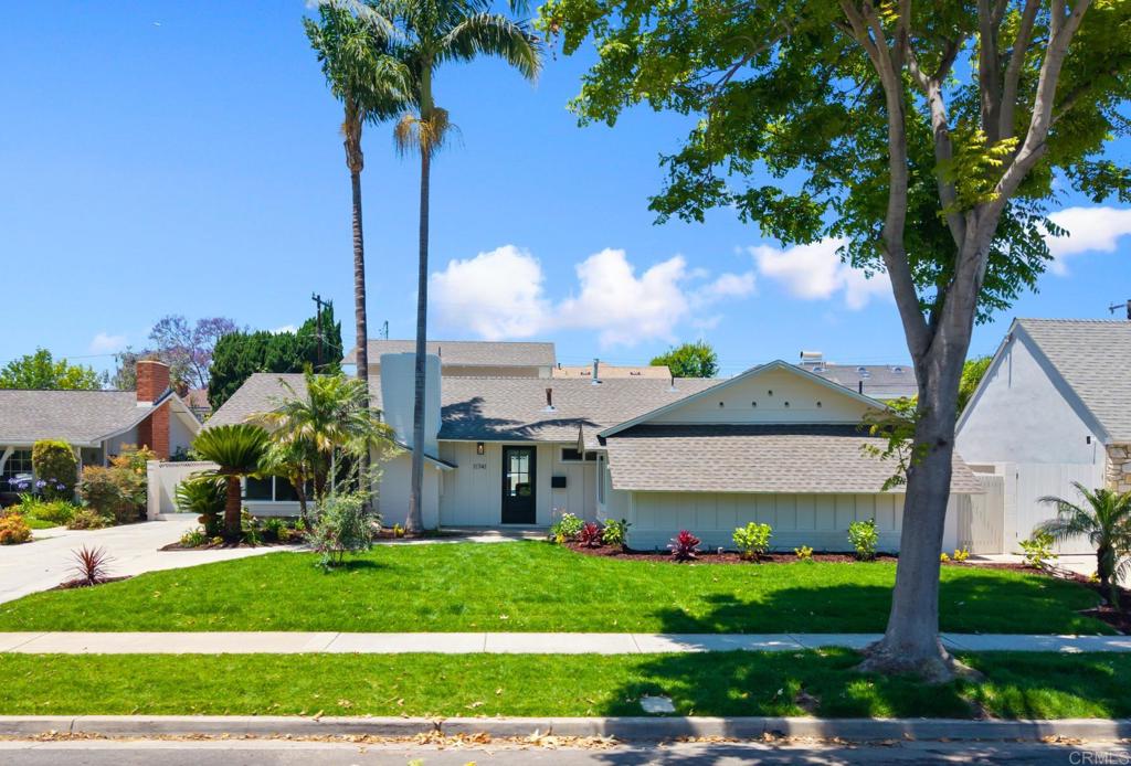 This enchanting home combines classic charm with thoughtful modern touches, all wrapped around a sun-drenched pool and the effortless flow between indoor comfort and outdoor beauty. Step into a light-filled living room with vaulted ceilings, a fireplace that anchors the space with warmth and style, and an expansive picture window framed by elegant decorative corbels, flooding the room with natural light and views of the lush front yard. The updated kitchen shines with rich, wood Shaker-style cabinetry, sleek quartz countertops, and a sunny breakfast nook that flows into a dining room complete with a convenient dry bar. Beyond, the cozy family room—featuring wood-beamed ceilings, a clean stucco fireplace, and expansive bi-fold doors opening to the pool—creates the perfect setting for relaxed evenings or lively entertaining. The primary suite is a serene retreat with a tastefully remodeled bathroom featuring soft neutral tones, gold-toned finishes, double sinks, a custom vanity, and a shower bench for added comfort. Two additional bedrooms offer flexibility for guests, work, or creative pursuits, while the remaining two bathrooms echo the same thoughtful design and quality. Tucked on a quiet, tree-lined street in a highly sought-after neighborhood, this home is located within the award-winning Los Alamitos School District and just minutes from parks, shopping, and dining. The surrounding community is known for its pride of ownership, wide boulevards, and welcoming spirit. Experience the lifestyle you’ve been waiting for!