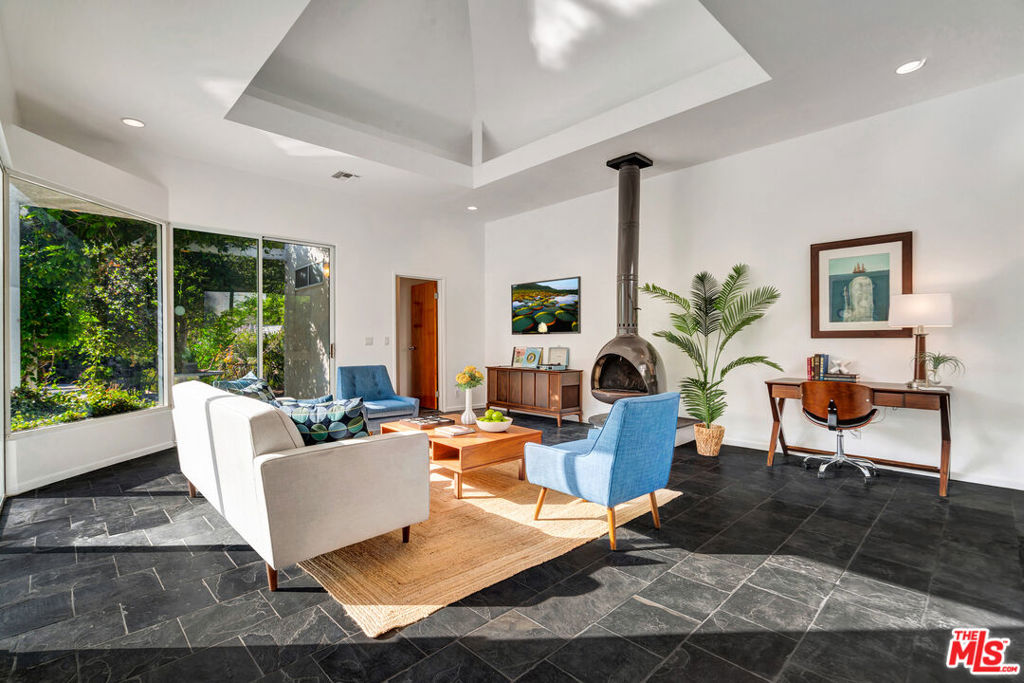 Welcome to 16771 Addison St on the market for the first time in over 55 years! Set in one of Encino's most beloved pocket neighborhoods, this 3-bed, 3-bath home offers 2,271 sqft of living space on a spacious 8,251 sqft lot. In the 1990s, the owner lovingly updated the home to reflect a mid-century modern vibe adding dramatic vaulted ceiling, striking black slate floors, skylights, custom doors, and a stunning circular freestanding fireplace as the centerpiece of the great room. The home has been well maintained over the years with thoughtful upgrades including copper plumbing, central HVAC, newer windows, and large sliding doors that open to a private backyard retreat complete with a swimmer's pool, mature shade trees, and lush gardens. Whether you're looking for a classic you can make your own, an investor seeking a value-add, the possibilities here are endless. Trust sale no court confirmation required. Just blocks to Los Encinos State Historic Park, Encino Park, shops, restaurants, and more!