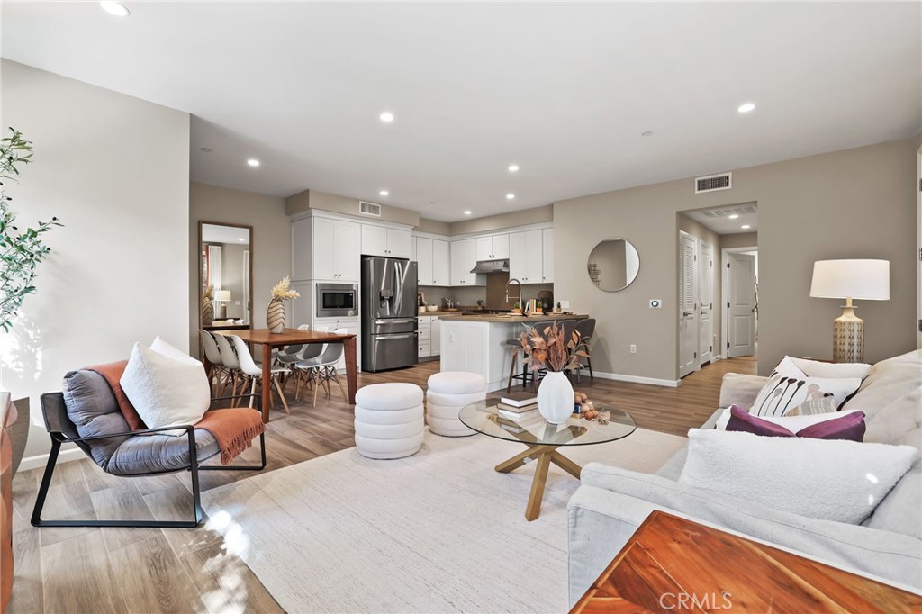 Discover this immaculate single-level condo in the desirable Avalon community of Eastwood Village. Offering 2 spacious bedrooms and 2 full baths, this home blends modern style with comfort in an open-concept floor plan. The inviting living room is perfect for everyday living and gatherings, while the master suite features a walk-in closet and a private porch for relaxing or entertaining. Gourmet kitchen with stainless steel appliances, gas range, microwave, dishwasher, vent hood, upgraded white satin-finish cabinetry with soft-close hinges, and quartz slab counters with backsplash. Master bath with upgraded shower enclosed in frosted rain glass and quartz countertop; guest bath with upgraded counter. Fresh interior paint, recessed lighting with upgraded conduit, upgraded "wood like" ceramic tile plank floors and carpet, and additional insulation for comfort. Darling front patio greets guests and is a great place to chill after work or on weekends. Two car Tandem Garage with direct access. This area is one of Irvines most popular Villages. Walk to acclaimed Eastwood Elementary School located within the Village, easy access to Jeffrey Open Space Trail, and Resort Style amenities for swim, play and picnic. Fantastic Walkability: Enjoy shopping and Dining at nearby Cypress Village Center, Woodbury Town Center, Orchard Hills,
or Irvine Spectrum, all just minutes away. Easy access to freeway.