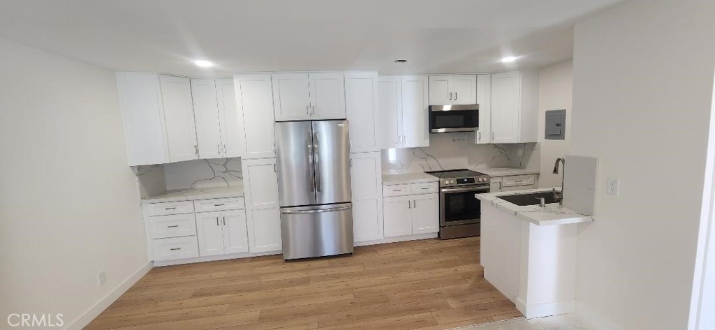 Stunning Remodeled Two Bedroom / Two Bath Upper End Location South Coast Metro Area Condo . Features include ; New high end Hardwood Style SHAW CORETEC Vinyl Plank Flooring & Berber Carpeting ( OWNER IS OPEN TO INSTALLING VINYL PLANK FLOORING THROUGHOUT ) , Dream Kitchen has a Contemporary Open Design with New White Quartz Counters & Backsplashes up to the upper cabinets / New Stainless Frigidaire Appliances ( DOUBLE DOOR REFRIGERATOR / Microwave / Dishwasher / Slide In Electric Stove Oven ) / New solid wood White Shaker Cabinetry with soft close features & pull outs / Stainless Sink , Recessed Lighting with dimmers , Master Bedroom has New Mirrored Wardrobe Doors & a Private Bath with a Tiled Walk in Shower with Bench & Frameless Door , Hall Bath also has new mirrored wardrobe doors , New "Payne" Central AC & Furnace , New Double Pane Vinyl Windows & Slider , New high end Window Coverings , New Bath Vanities , New Bath Mirrors , Smooth Ceilings , New Raised Panel Interior Doors & Closet Doors , New Electrical Breaker Box ( increased capacity ) , New Shower Valves , New Angle Stops , New Toilets , New Cabinet Pulls & Knobs , New Plumbing , New Garbage Disposal , Re Glazed Bath Shower & Tub , New High Baseboards , New Bath Lighting , New Faucets , includes close by carport # 325 & one unassigned open space , choice interior location facing away from the sun ! HOA dues include gas / water / trash / sewer , Gated Woodside Village community offers 3 pools & spa / clubhouse / across the street from the city of Costa Mesa , community has plans for upgrades such as the re done 2501 # A building & much more ! This Completely Renovated Condo might be the nicest Two Bedroom ever offered in Woodside Village , owner has upgraded this one like no other !!