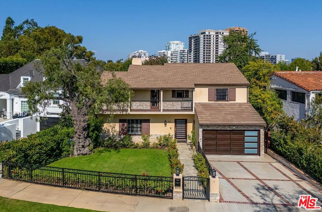 Situated in Premier location in the esteemed Little Holmby neighborhood, this updated Monterey Traditional features a coveted modern open floorplan combined with all its original warmth and character with dark wood flooring and crown moldings throughout. Entering the home through a gated front garden reveals streams of light cascading in from every angle through a myriad of new large windows. The floorplan boasts a breathtaking great room flowing seamlessly from a gracious formal living room with a baronial marble fireplace to a comforting family room with second fireplace to a large open dining area with wet bar creating the perfect setting for large scale entertaining or causal relaxation with the family. Adjoining the dining area is a gourmet eat-in kitchen with large center island, stone countertops, high-end stainless appliances and copious amounts of storage ready for the seasoned chef or aspiring cook. The rear of the main level opens through multiple French doors to an expansive redone deck area with motorized awnings offering multiple seating areas and sweeping treetop, mountain and city light views. In addition, there is a convenient powder room and large laundry room. All four bedrooms are upstairs including gracious master suite with dual closets, sumptuous full marble accented bath, and front balcony, plus a large second bedroom with en suite bath and two additional bedrooms with a shared hallway full bath giving an unlimited number of options for families or professional work at home executives. The house also includes a bonus lower level, 546 sqft not included in total, accessible by steps down from the main deck featuring a sizable multi-purpose room with bath, perfect for media room, gym or game room plus a private patio and enchanting extra-large spa calling for a long dip to unwind after a long day or workout, all overlooking a romantic landscaped garden with fountain beyond. Additional improvements over the last 10 years include newer HVAC and roof, updated electrical and plumbing, and EV charger in the two-car garage. Coupled with its modern and classic features, the home is mere moments from the relaxing atmosphere of Holmby Park, the world-class shopping at Westfield Century City, the glamour of Beverly Hills, and the cultural offerings of UCLA and Westwood. It also allows access to the prestigious, award-winning Warner Avenue Elementary School. This is an amazing opportunity to enjoy all the best of what Little Holmby offers.