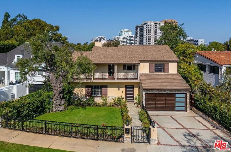 Situated in Premier location in the esteemed Little Holmby neighborhood, this updated Monterey Traditional features a coveted modern open floorplan combined with all its original warmth and character with dark wood flooring and crown moldings throughout. Entering the home through a gated front garden reveals streams of light cascading in from every angle through a myriad of new large windows.  The floorplan boasts a breathtaking great room flowing seamlessly from a gracious formal living room with a baronial marble fireplace to a comforting family room with second fireplace to a large open dining area with wet bar creating the perfect setting for large scale entertaining or causal relaxation with the family.  Adjoining the dining area is a gourmet eat-in kitchen with large center island, stone countertops, high-end stainless appliances and copious amounts of storage ready for the seasoned chef or aspiring cook.  The rear of the main level opens through multiple French doors to an expansive redone deck area with motorized awnings offering multiple seating areas and sweeping treetop, mountain and city light views. In addition, there is a convenient powder room and large laundry room. All four bedrooms are upstairs including gracious master suite with dual closets, sumptuous full marble accented bath, and front balcony, plus a large second bedroom with en suite bath and two additional bedrooms with a shared hallway full bath giving an unlimited number of options for families or professional work at home executives. The house also includes a bonus lower level, 546 sqft not included in total, accessible by steps down from the main deck featuring a sizable multi-purpose room with  bath, perfect for media room, gym or game room plus a private patio and enchanting extra-large spa calling for a long dip to unwind after a long day or workout, all overlooking a romantic landscaped garden with fountain beyond.  Additional improvements over the last 10 years include newer HVAC and roof, updated electrical and plumbing, and EV charger in the two-car garage. Coupled with its modern and classic features, the home is mere moments from the relaxing atmosphere of Holmby Park, the world-class shopping at Westfield Century City, the glamour of Beverly Hills, and the cultural offerings of UCLA and Westwood. It also allows access to the prestigious, award-winning Warner Avenue Elementary School. This is an amazing opportunity to enjoy all the best of what Little Holmby offers.