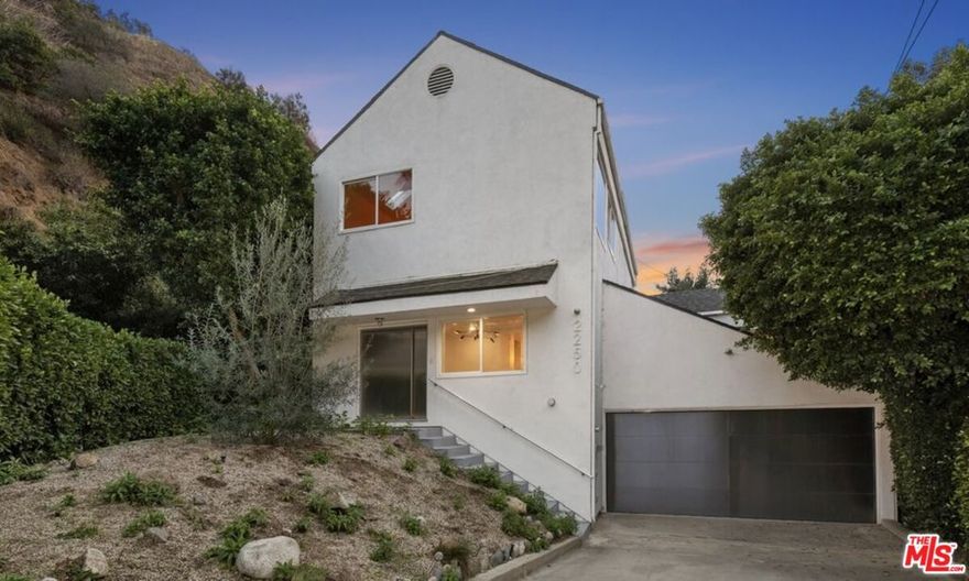 Must see this Lower Nichols Canyon oasis with modern decorator finishes and entertainer's layout. Set on a private corner lot with no direct neighbors and across from the natural creek.  When you enter the massive pivot metal door into the gallery like living room with tall ceilings, stamped panel ceiling and natural light you are transported into a luxury haven. This is an ideal canvas for elevated design with wide plank French oak floors, stunning chrome fixtures and select finishes throughout.  The show stopping marble and metal kitchen featuring FLATIRON NYC custom cabinets, exposed wood beams and top of the line appliances flows to the large covered deck and manicured gated yard. The upstairs primary suite is a retreat with vaulted ceiling, skylights, huge walk in closet and out of this world marble bathroom with polished steel standalone tub and custom vanities.  The lush and private landscaped backyard with flat grassy area, manicured paths and architectural fountains is perfect for entertaining and leads to the lower level detached studio.  The garage is vaulted with floor to ceiling storage cabinets and has a 200sqft bonus space ideal for office or gym. Will not find a nicer move in ready home surrounded by multimillion dollar neighbors.