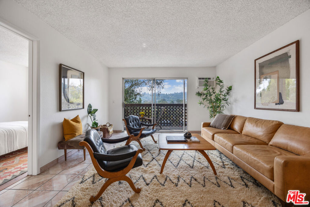 Step into this bright and airy 2-bedroom, 2-bathroom condo offering views of city lights, hillsides and parks. Enjoy your morning coffee from your private balcony. The kitchen is equipped with new granite countertops, new dishwasher and new overhead microwave. The primary bedroom has an ensuite bath which includes space for a stackable washer & dryer, while the second bedroom is ideal for guests, a home office, or a cozy den. Arroyo Seco Villas is a private gated community, quietly perched on a hill, situated just moments from the vibrant shops and dining along trendy Figueroa Street. Relax by the pool & spa or hang out in the BBQ picnic area with friends. The complex also boasts large a grassy area with mature landscaping, a fenced-in kids' play area and basketball court. This unit comes with a 2-car carport. Conveniently close to the 110, 101 and 5 freeways, and a few blocks from the Gold Line and Farmers Market. This condo offers convenience and great value in one package. Don't miss the chance to make it yours!