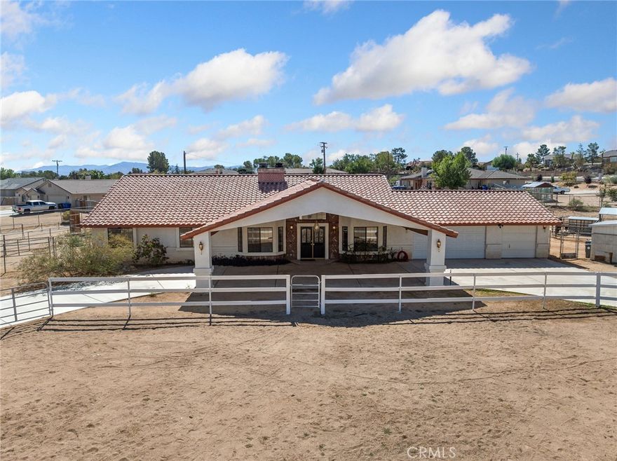 Welcome to this well maintained traditional ranch style home situated on a spacious 1.16 acre corner lot in the highly desirable neighborhood of Desert Knolls. Offering 4 bedrooms and 2.5 bathrooms, this home combines comfort, functionality, and added equestrian amenities in one exceptional package. Step inside the formal foyer and through the arches to the formal living and dining rooms. Perfect for gatherings, the formal living room features a brick accented fireplace with raised hearth and mantel, while the formal dining room provides an elegant setting for entertaining and hosting those special events throughout the year. The Island Kitchen is a chef's delight with abundant cabinetry, a walk-in pantry, an eating area and a generous breakfast bar overlooking and open to the spacious family room. Family room offers a warm setting inspired by another brick accented fireplace with raised hearth and mantel as well as high ceilings, natural lighting from the many windows and glass door that leads to the outside patio area with an intimate spa for relaxation. The primary suite is a private retreat with a sun-filled sitting area, French doors to the outside and a large walk-in closet. The primary bath offers dual sinks, soaking tub and separate shower. Three additional bedrooms are generously sized with mirrored wardrobes. Equestrian lovers will appreciate the improved horse facilities including three corrals with shelters, a hay barn, large turnout with shelter and a moderate arena. The property also features two outbuildings for additional feed and storage. A rounded driveway with drive through portico adds both charm and convenience. Modern upgrades include a nearly new, PAID FOR SOLAR SYSTEM, providing ample energy for a large household and a WiFi security system with cameras and alarm for peace of mind. This property offers the perfect blend of rural living with modern amenities. Don't miss the opportunity to call this exceptional property your new home.