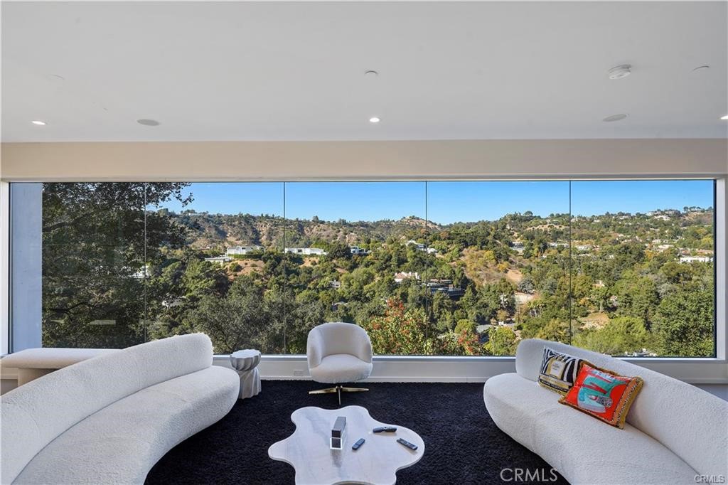 Exquisite Beverly Hills Estate. Discover unparalleled luxury in this stunning Beverly Hills property. This fully furnished home has 6 spacious bedrooms, 5 elegantly designed bathrooms, and spanning an impressive 6,244 square feet, this home is a masterpiece of modern living, nestled amongst the clouds, the property offers a perfect blend of serene privacy and breathtaking panoramic views. From every angle, floor-to-ceiling windows frame the cityscape, bathing the interior with natural light and showcasing the serene landscape. The outdoor space is equally captivating, featuring a spectacular pool that appears to float above the horizon—ideal for entertaining or relaxing while enjoying the awe-inspiring vistas. Set in an exclusive neighborhood with celebrity neighbors, this home offers an unmatched location that combines prestige and tranquility. Whether you're hosting lavish gatherings or seeking a peaceful retreat, this property delivers on every level. Make this iconic residence your sanctuary in the heart of Beverly Hills.