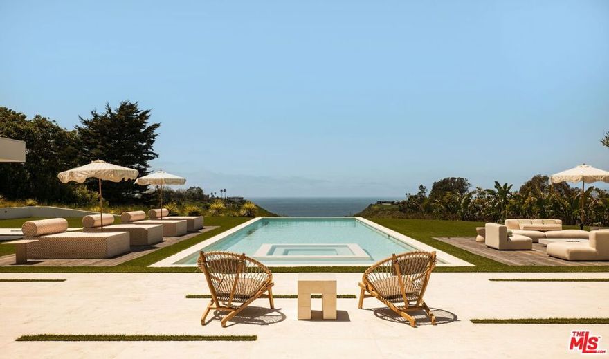 Introducing TerraLume, Malibu's newest iconic estate nestled within the ultra-exclusive Point Dume enclave. Spanning 2.25 acres of pristine grounds with commanding panoramic ocean views, this 8,500 sq ft, 6-bedroom, 8-bathroom masterwork offers the pinnacle of architectural sophistication and resort-style living. A harmonious fusion of contemporary design and materials, TerraLume features board-formed concrete walls, curated stone finishes, and floor-to-ceiling disappearing glass doors that seamlessly blend indoor and outdoor living. Highlighting Malibu's legendary sunsets at every turn. Enter through a tranquil lagoon to a grand 8x10 custom copper pivot door, leading into a dramatic double-height entry and voluminous open spaces.  Every detail has been hand-selected for its artistry: handmade chandeliers, handcrafted wood louvers, etched copper walls, and a bespoke Italian kitchen. The floating staircase ascends to a private upper level featuring an opulent primary suite with two fireplaces, a spa-inspired bath retreat with hand-carved marble vanities, a sculptural stone soaking tub, and a steam shower framing unforgettable ocean vistas. Outdoor amenities rival world-class resorts: a covered outdoor kitchen and bar, 70-foot pool and spa, detached guesthouse, fitness studio with sauna, and gated motor court with parking for up to 20 vehicles. Enjoy private access to Little Dume Beach through the coveted Riviera III beach key.