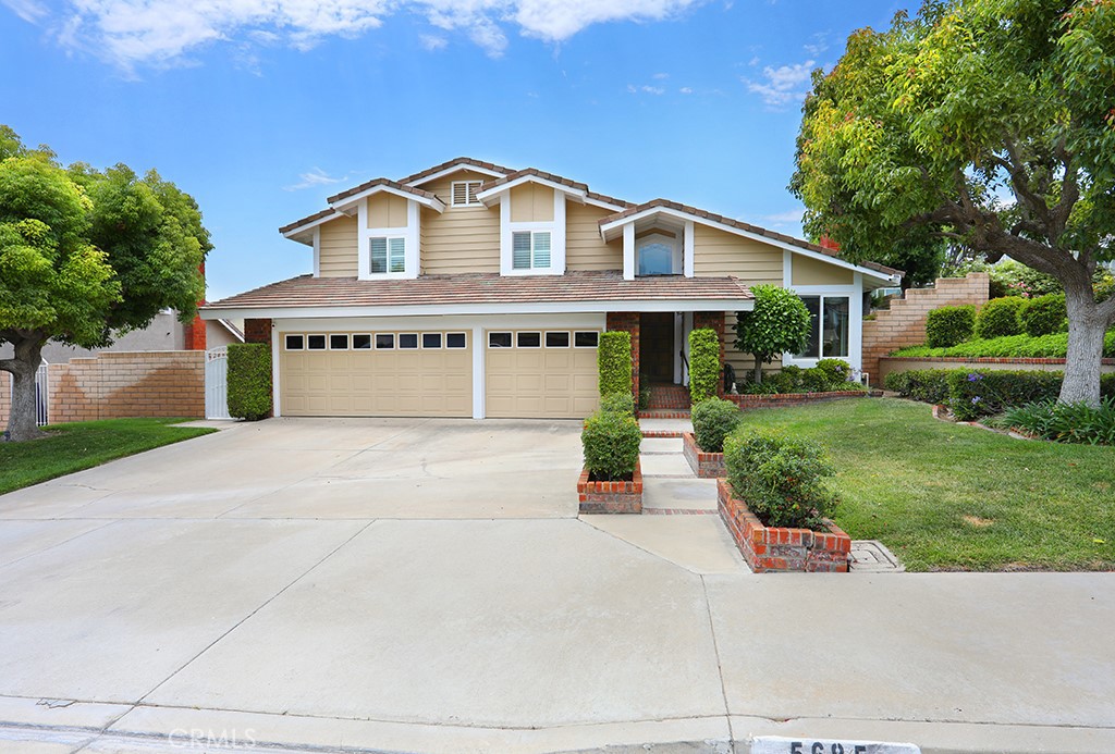 Welcome to this beautifully appointed 4 bedroom 3 bathroom home primely situated in the heart of Yorba Linda. Spanning 2,484 sq. ft. on a generous 8,100 sq. ft. lot, this property offers a perfect blend of comfort combined with traditional elegance. As you enter, you’re greeted by a spacious formal living room featuring vaulted beamed ceilings, custom etched windows and a cozy fireplace with custom mantel which seamlessly flows into the formal dining room. The charming kitchen is pristinely maintained with rich wood cabinetry, sparkling white tile counters, stainless steel dishwasher and refrigerator, recessed lighting, a walk in pantry and a delightful eat in kitchen area which overlooks the private backyard. Down a few steps you'll find a separate family room with fire place, wet bar and patio slider with backyard access. There is also a spacious downstairs bedroom and a full bath, perfect for guests or multi-generational living as well as an interior laundry room with additional storage. Head upstairs and discover the enviable primary suite with vaulted ceilings, dual closets, and a bright and luxurious bathroom with an oversized soaking tub, walk-in shower, and dual vanities. Two additional bedrooms share a secondary bathroom equipped with dual sinks. Step outside to your private backyard with ample space for entertaining! There is a large grassy area, a built in BBQ, lush landscape and plenty of room to dine al fresco under the a new patio cover. Completing the exterior is a spacious side yard with RV potential. Additional improvements include newer exterior paint, upgraded windows throughout, plantation shutters, custom baseboards, newer air conditioning, heating, and water heater. This home is zoned for prestigious award winning schools, and is conveniently located near shops, entertainment, and easy access to the 91 and 241 freeways. Don’t miss this incredible opportunity to own a remarkable home in the land of gracious living!