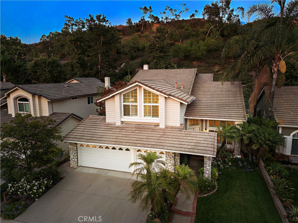 Welcome to over 2500 square feet of beautifully upgraded living space in the sought-after community of Robinson Ranch. This 5-bedroom, 3-bathroom home offers the perfect blend of functionality, style, and a setting that embraces nature and neighborhood charm.
As you enter, a raised foyer and custom staircase set an elegant tone, leading into spacious formal living and dining areas with rich wood flooring and an abundance of natural light. Downstairs, the fifth bedroom—currently styled as a home office—features upgraded French doors and offers ideal flexibility for guests, work, or multigenerational living.
The heart of the home is the extensively remodeled kitchen, thoughtfully designed for the modern chef. Enjoy granite countertops, a high-end Dacor gas range, custom cabinetry with pull-out drawers, spice organizers, under-cabinet lighting, glass-front display doors, and detailed crown molding. A built-in serving station along the breakfast nook wall provides added functionality and charm, perfect for casual meals or entertaining.
Upstairs, the primary suite offers a peaceful escape with hillside views, two walk-in closets, and a spa-inspired bath with a soaking tub, separate shower, and dual vanities. Outside, the backyard is extremely private , offering a serene space to unwind, entertain, or take in the natural surroundings.
Located in The Springs at Trabuco Highlands, this home is part of a community known for its award-winning schools, nearby hiking and biking trails, and close proximity to O’Neill Regional Park, Tijeras Creek Golf Course, and the RSM Lake. HOA amenities include a gated pool and spa, sport courts, playgrounds, BBQ areas, and beautifully maintained parks.
This is more than a home—it’s a lifestyle. Discover what makes this residence in Robinson Ranch truly special.