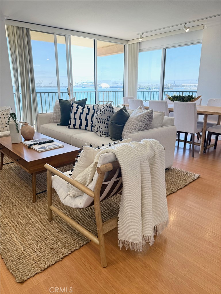 Wake up to panoramic Pacific vistas in this stunning two bedroom oceanfront condo, showcasing the very best of coastal living. The condo features an open-concept layout that is ideal for both relaxing and entertaining. The living room boasts a wrap-around balcony and floor-to-ceiling windows that flood the space with natural light and delivers breathtaking ocean views. You'll enjoy practicing your culinary skills in the spacious kitchen, with modern cabinetry and breakfast bar. The serene primary bedroom retreat includes another private balcony, a feature only with this floor plan, where the sounds of the surf create a tranquil atmosphere. Whether you’re sipping morning coffee or enjoying guests with the ocean as your backdrop, this condo offers a lifestyle of effortless luxury. The building offers a resort-style experience with a saltwater pool, perfect for basking in the sun or unwinding with a refreshing dip. Additional amenities include a jacuzzi, sauna, a gym, and spacious ocean view deck for relaxation and socializing. Step outside your abode and you'll find yourself drawn to the sandy shores and scenic walking paths that can take you to Shoreline Village and many great restaurants, and you’re only minutes away from popular Belmont Shore and downtown. This oceanfront home presents a rare opportunity to indulge in the ultimate beachside lifestyle. Whether you’re looking for a full-time residence or a tranquil oceanfront getaway, this is coastal California living at its finest!