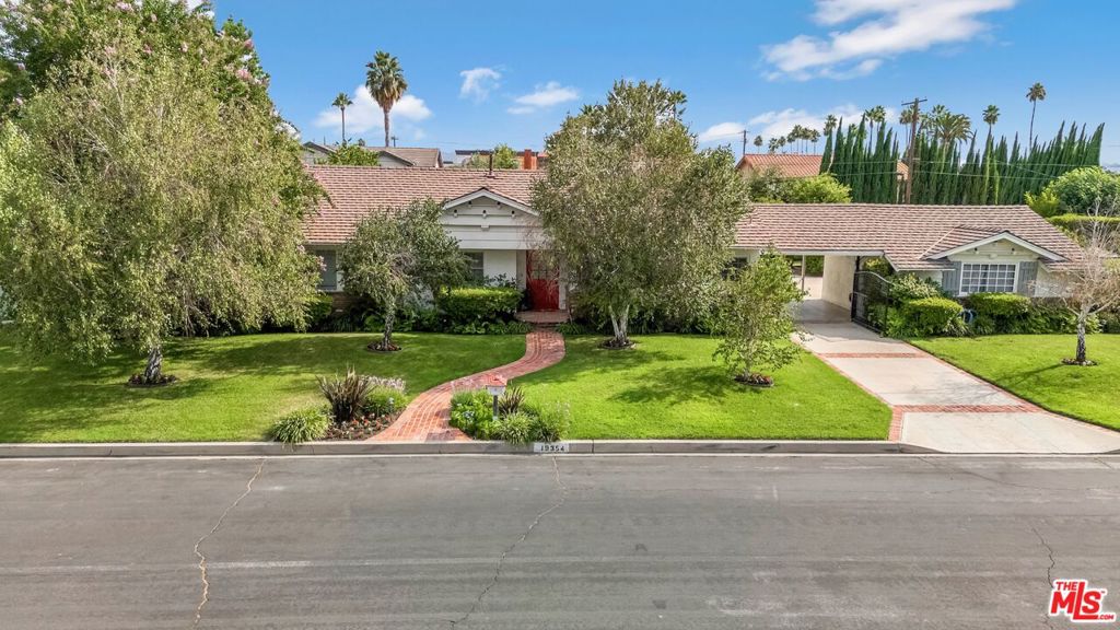 First time on the market in 60 years! Welcome to this beautifully maintained 4-bedroom, 3-bathroom home, proudly owned and loved by the same family for over six decades. Nestled in the highly sought after Devonshire Highlands neighborhood, this inviting residence sits on a generous lot with incredible curb appeal and a backyard designed for both relaxation and play. Inside, you'll find a thoughtfully updated chef's kitchen featuring an eat-in breakfast area, modern cabinetry, gas appliances, and ample counter space perfect for cooking and entertaining. The home also includes recessed lighting, a full laundry room, and a spacious, well-designed layout ideal for your growing household. The primary suite offers comfort and privacy, including a walk-in closet, large sitting room perfect for an office or gym, and en-suite bathroom. Three additional bedrooms provide space for guests, a home office, or creative pursuits. Natural light fills every room, creating a warm and welcoming atmosphere throughout. Step outside to a backyard that's truly special, with fruit bearing trees and a perfect blend of a large grassy play area and expansive concrete space ideal for basketball, soccer, scooters, outdoor dining, or future improvements like a pool or outdoor kitchen. Plenty of room for parking with a long driveway and 2 car garage, as well as enclosed RV parking with hookups. Located close to parks, top-rated schools, shopping, and freeway access, this Northridge gem combines classic charm with modern touches. Whether you're looking to restore its timeless character or customize it further, this home offers an incredible opportunity to create lasting memories in a space that has already been so loved. Don't miss this once-in-a-generation opportunity!