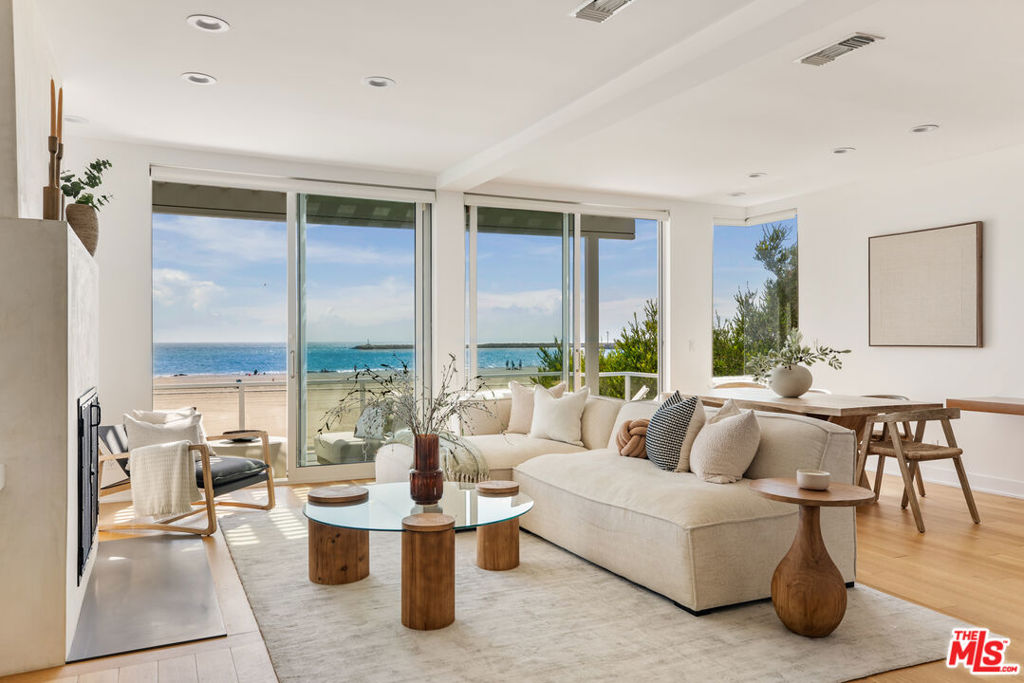 Imagine waking up every day to the white sand and blue waters of the Ocean right outside your door. Welcome to a stunning modern beachfront home, located in an exclusive enclave of Playa del Rey, where opportunities to own a gem like this are few and far between. Step inside and be transported by an open floor plan with soaring ceilings, abundant natural light and breath-taking panoramic views of the sand, sea and sky. Wall-to-wall glass doors slide open to reveal a spacious covered sun deck, perfect for al fresco dining and unforgettable sunset gatherings. Indulge your culinary passions and entertain with ease in the gourmet kitchen with sleek quartz counters, top-of-the-line appliances and a generous pantry. On the lower level, a Great Room with ocean views and direct beach access, has its own kitchen, and is ideal for more casual dining, game and movie nights, or a dreamy home office. The Great Room opens onto a covered patio and beautifully landscaped garden with a private pathway to the widest and most serene beach on the Westside. And steps from your front door is the 22-mile beach bike path. Incredible location in sleepy Playa del Rey is moments from fine dining, coffeehouses, Playa Vista, and everything the Westside has to offer. This is coastal living at its finest!