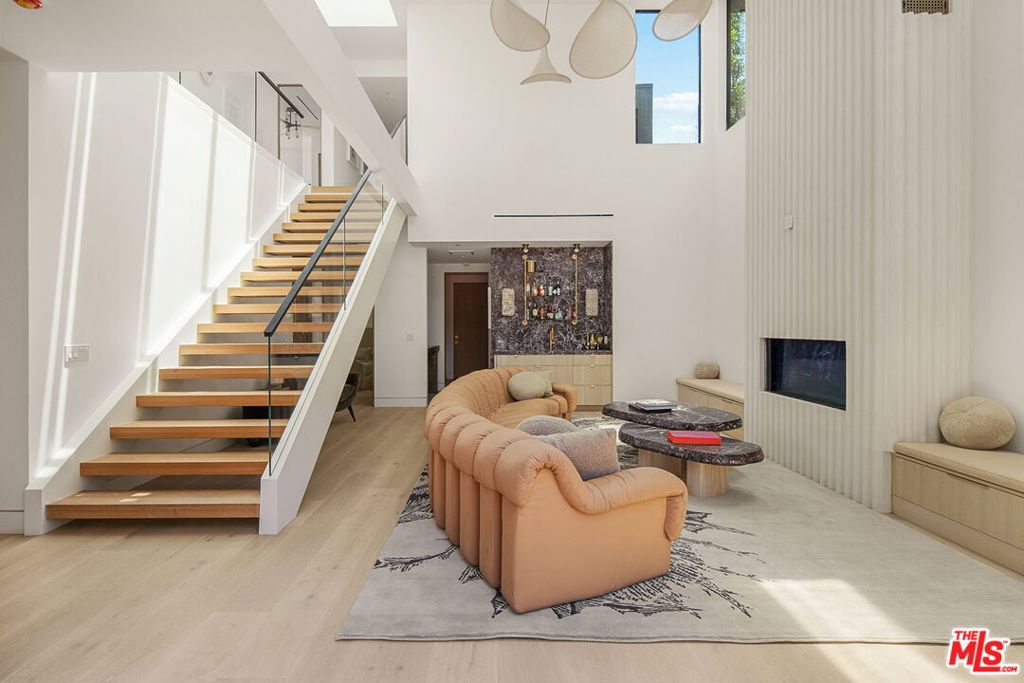 Tucked away in one of Venice's most desirable pockets, just moments from the iconic Abbot Kinney, this brand-new architectural residence is a private offering of rare design pedigree. Meticulously crafted by renowned local architects Electric Bowery, the home seamlessly blends bold materiality with coastal sophistication. Step inside to soaring ceilings, an open-concept floor plan, and curated spaces designed for elevated living. Every finish has been thoughtfully selected and masterfully executed from the live brass Honey Onyx powder room to the Corteccia Natural Quartzite in the first-floor bath, the Tiger Eye Onyx in the guest bath, and the showstopping Calcutta Sunset marble in the primary suite. The media room's Lilac Marble wall adds a refined, artistic touch. At the heart of the home, the kitchen is a true statement piece featuring Ceppo marble countertops, white oak custom cabinetry, and designer Rejuvenation hardware. The adjacent dry bar, clad in striking Rosso Levanto marble, sets the tone for sophisticated entertaining. Indoor-outdoor living is effortless here, thanks to a tranquil pool that blurs the line between the interior and lush exterior spaces. A spacious three-car garage completes the home, ensuring both functionality and convenience. This is not just a home, it's a design-forward sanctuary where luxury, privacy, and location converge. Available exclusively off-market. Private showings available to qualified buyers. FINISHES & FURNITURE LIST AVAILABLE UPON REQUEST. ALSO AVAILABLE FOR SALE $6,700,000.