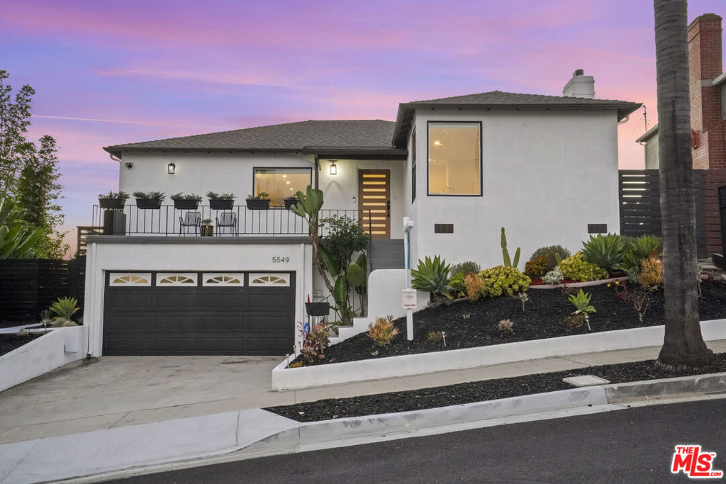 Picturesque Windsor Hills stunner, with impressive panoramic city to coastline views, and peek-a-boo of the Pacific ocean and Catalina Island. Located on the prestigious Onacrest Drive, this home has been thoughtfully remodeled for buyers who love to entertain and enjoy the indoor-outdoor California lifestyle. A swank new door greets you on the stylish entry patio that has views of the surrounding city lights and treetops. You'll appreciate the clever floor plan that places the main living areas on the 2nd floor to take advantage of the stellar views over the hill. Formal Living Room with elegant white tiled fireplace and 2 bright large windows letting in tons of natural light. Featuring an open and welcoming white kitchen with large island, quartz counters, and plenty of storage. All stainless steel appliances incl French door refrigerator & separate wine/beverage fridge. Flexible dining area perfect for large gatherings and holiday meals. The dining area has direct access to the balcony deck and cozy fire pit. Enjoy a glass of wine on the deck surrounded by lush greenery and panoramic sunset views. An outdoor staircase from the deck allows easy access to the backyard. There are 2 bedrooms on the entry level that share a newly remodeled full sized bathroom with walk-in shower and jetted spa tub. Downstairs you'll find a private laundry room, office nook or playspace area, and two more bedrooms both ensuite. The primary bedroom is ensuite, w/walk-in closet and direct access to it's own backyard patio. You'll also find an outdoor hot tub and plenty of space for kids and pets to play. Newly landscaped with sustainable, easy to maintain turf grass & drought tolerant plants ideal for the Southern California climate. Multiple Terraces below backyard are perfect for gardening, hobbies or future potential ADU. Attached 2 car garage with direct access and EV charger. Many upgrades incl New LED Lighting, Tankless Water Heater, Water Softener, Ring Doorbell and Alarm System. This home ideally located and is convenient walking distance to many shops including Hilltop Coffee Co, Simply Wholesome Grocery as well as Kenneth Hahn Park and beautiful local walking trailheads. Easy access to beaches, freeways, and the new Sofi Stadium. This updated classic Windsor Hills dream property is stylish, modern, mindful and checks all the boxes.