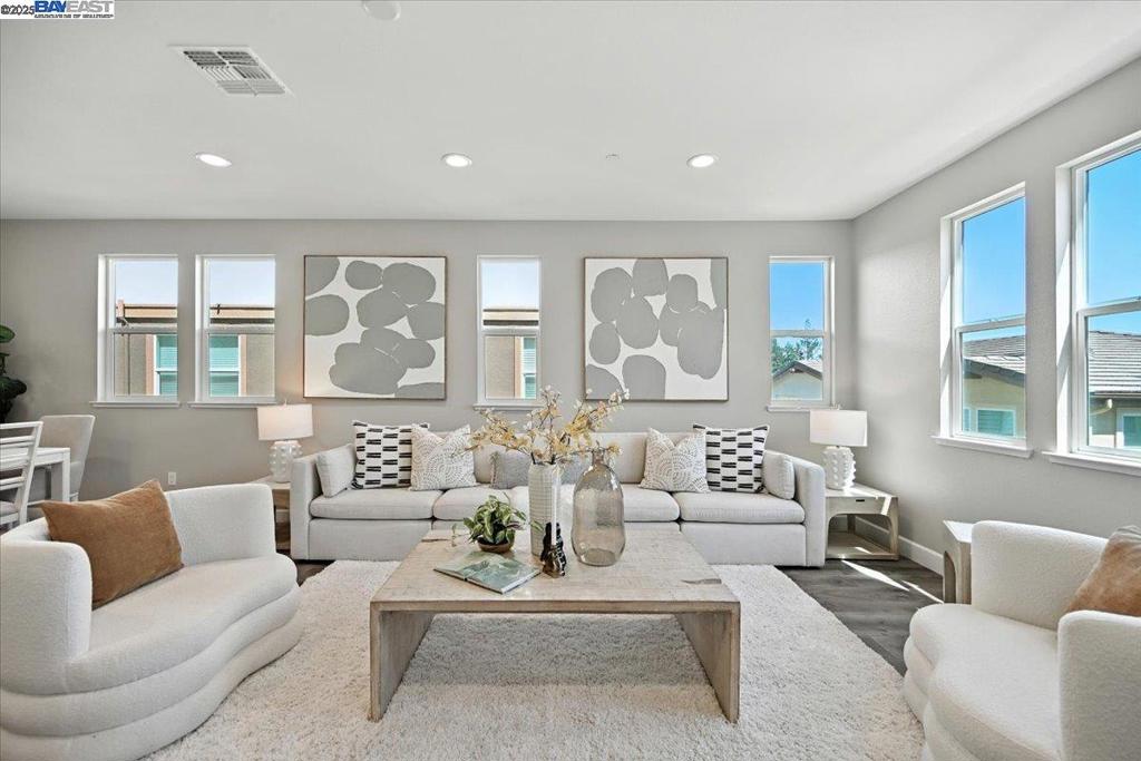 Welcome to 437 Ryan Terrace—an elegant tri-level corner townhome in the heart of San Ramon, a city celebrated for its top-rated schools, family-friendly vibe, and abundant parks. This spacious 3-bedroom + office, 3.5-bath residence blends comfort and functionality with designer finishes throughout. The gourmet kitchen boasts a large quartz island, gas cooktop, stainless steel appliances, and generous cabinetry. Enjoy luxury flooring in the main living areas, brand-new carpet in all bedrooms and hallways, and smart dual-zone climate control. Start your mornings on the private balcony, then retreat upstairs to a serene third level featuring a luxurious primary suite with dual vanities, a custom walk-in closet, and stunning mountain views. Two additional bedrooms share a full bath, while the laundry room offers custom built-ins. The versatile ground-level office (no closet) includes a full bath—ideal as a guest room, workspace, or media lounge. Additional highlights include a tankless water heater, EV charging outlet, and a 2-car side-by-side garage. All this in a quiet, kid-friendly community with easy access to I-680, shopping, and top schools—don’t miss this exceptional opportunity!