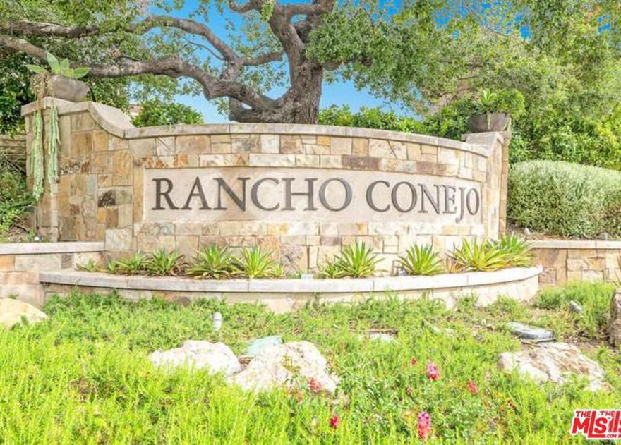 Located in the exclusive guard-gated community of Rancho Conejo, this beautifully maintained home offers an ideal blend of comfort, elegance, and privacy. The impressive curb appeal features Mediterranean styling, lush landscaping, and a welcoming three-car garage. Inside, the home showcases a gourmet kitchen with Viking appliances, rich cherry cabinetry, granite counters, and a center island that opens to the family room with a custom stone fireplace and built-in entertainment center. Soaring ceilings and large picture windows fill the formal living and dining rooms with natural light, creating an inviting space for gatherings. The spacious primary suite includes a tray ceiling, plantation shutters, and a spa-like bathroom with soaking tub, dual vanities, and separate shower. Additional bedrooms are generously sized and thoughtfully appointed. The backyard is perfect for entertaining with multiple seating areas, mature landscaping, and a relaxing patio retreat. Enjoy all that Rancho Conejo has to offer, including 24-hour guarded security, community pools, spas, parks, playgrounds, and access to scenic walking trailsall within minutes of top-rated schools, shopping, and the best of the Conejo Valley lifestyle.