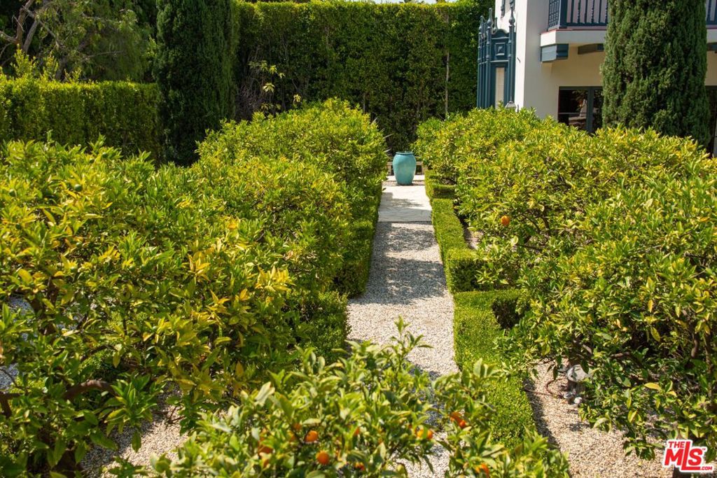 A rare double lot totaling nearly one acre of gated park-like grounds on one of the best streets in the Beverly Hills Flats, this gorgeous Wallace Neff Spanish estate has been flawlessly restored & expanded. A true masterwork, this estate is the perfect combination of authentic details, fine craftsmanship & the best modern amenities. A dramatic foyer with a curved staircase under a spectacular hand-painted dome ceiling leads to a sensational living rm, wood-paneled library & fairytale playroom. Formal dining rm & gourmet kitchen w/breakfast area. Elegant arched windows & doors throughout lead to an outdoor oasis w/vast rolling lawns, fountains, pool, spa, green house & pergola lounge. The 2nd level of the main residence features a TV lounge & 3 bdrms including the lavish primary suite w/balcony & spa-like bth. In addition to the main residence there is a Dolby certified home theater w/2 guest suites above, a gym, & 2nd large detached guest house/studio. Smart home powered by Crestron.