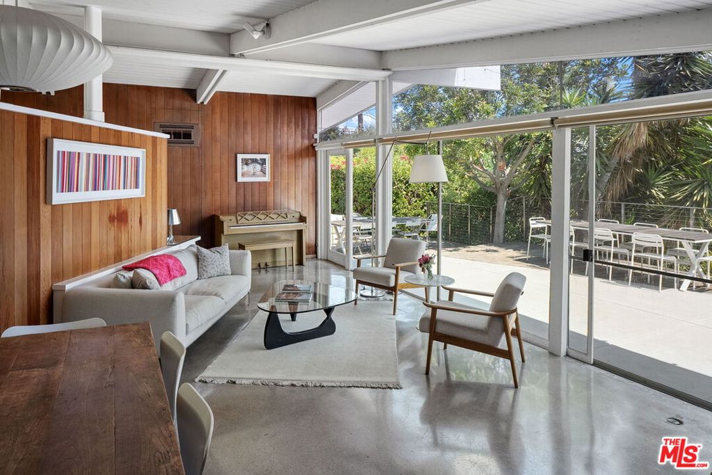 Discover Architectural Elegance in Brentwood. Welcome to the Siegel House at 12400 Deerbrook Lane, a rare Mid-Century Modern gem nestled in Crestwood Hills. Designed in 1950 by acclaimed architect A. Quincy Jones, this historically significant residence was the first built home of the planned 500 homes in this area. This single-story home offers three bedrooms and 1.75 bathrooms, with hallmark redwood post-and-beam construction and polished cement floors throughout. An open floor plan, large windows allow constant natural lighting, remodeled kitchen, framed by eight-foot sliding glass doors, creates a seamless indoor-outdoor flow, expanding the living space into the private, tranquil grounds with never ending views to the Ocean and city lights from the private patio area. In addition, enjoy the lower back yard for picnics or reading a book. Beyond its architectural significance, the property presents an exceptional opportunity: potential for historic designation and the associated Mills Act tax savings. Both a residence and a piece of design history, the Siegel House invites its next steward to preserve, enjoy, and make it their own.