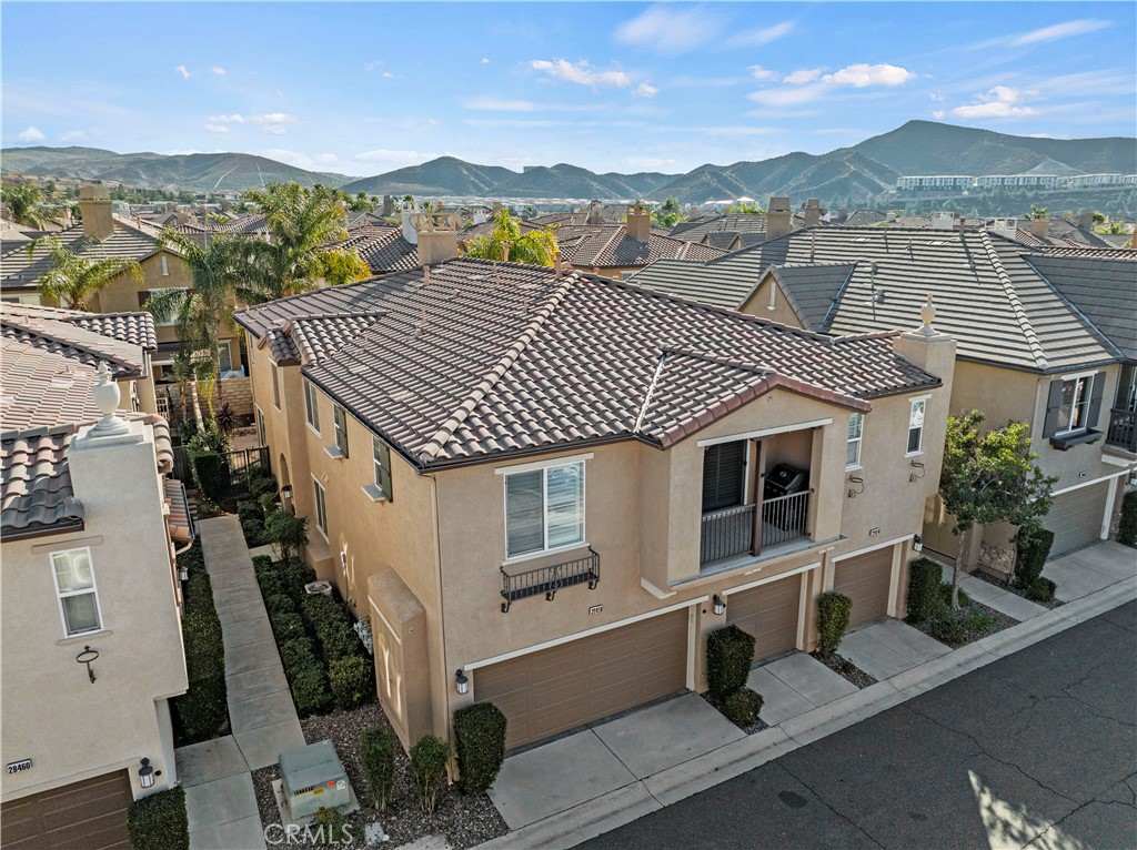 Chic & Modern Townhome in Mariposa at Plum Canyon Ranch! Welcome to this beautifully updated 2-bedroom, 2-bath residence in the heart of Saugus, offering a bright open layout and true turnkey living. Built in 2005, this home showcases fresh designer paint, sleek white countertops with striking marbled veining in the kitchen and bathrooms, newer stainless steel appliances, modern lighting and plumbing fixtures, newer resurfaced showers and tubs, and elegant plantation shutters throughout. Enjoy the convenience of an attached 1-car garage with direct access, additional covered carport, in-unit laundry hookups, and a private balcony with peaceful views. The Mariposa community is known for one of the lowest HOA fees in Santa Clarita with NO Mello Roos, while still providing resort-style amenities including a sparkling pool, relaxing spa, outdoor kitchen with BBQ areas, clubhouse, greenbelts, and playgrounds. Ideally located near shopping, dining, coffee shops, freeways, and award-winning schools, this home combines style, value, and move-in ready comfort—don’t miss the opportunity to make it yours!