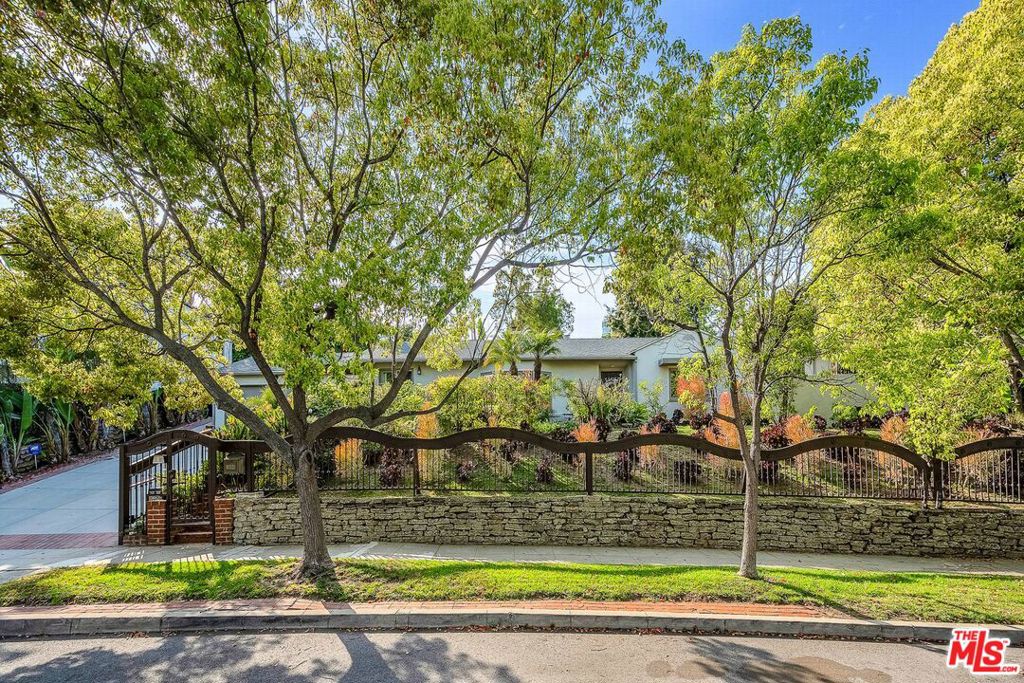 Discover timeless elegance and modern comfort in this beautifully appointed residence located in the heart of Comstock Hills. Set on an expansive 11,550 square feet lot, this property provides lush mature landscaping. Located on a quiet, tree-lined street, this stunning home offers refined living with exceptional attention to detail. This one story home features 4 bedrooms, 3.5 bathrooms and family room, spacious open-concept floor plan with contemporary flair and abundant natural light. Large living room with exposed vaulted ceiling and fire place, spacious formal dining room with wainscoting and coved ceiling, several skylights throughout the house. The primary suite offers a serene retreat with a luxurious en-suite bath and ample closet space, all other bedrooms are also generous in size. Gourmet kitchen boasts high-end appliances, custom cabinetry, sleek counter tops and opens to the breakfast area and family room with sliding doors to the large back yard. Step outside to a private backyard oasis with views of Century City, ideal for al fresco dining or weekend lounging with ample room to add a pool or garden oasis, other features include central heating/air conditioning and hardwood floors. Set on an expansive 11,550 square feet lot, this property provides lush mature landscaping. Minutes from UCLA, Century City, Beverly Hills, public transportation and freeways. This family home combines convenience with classic Los Angeles charm and provides a rare opportunity to live in a premier property on one of the largest lots in one of LA's most sought-after neighborhoods.