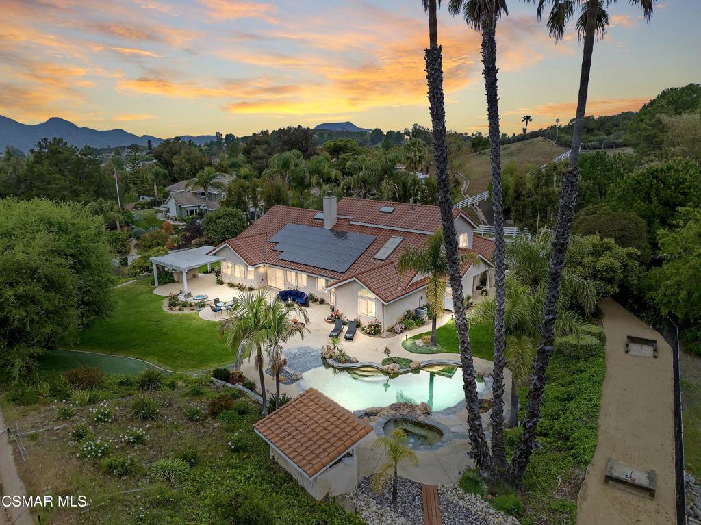 Nestled within an EXCLUSIVE GATED ENCLAVE of only four custom residences, this exceptional estate in Deer Ridge Estates offers unparalleled privacy, luxury, and sweeping garden and mountain views from nearly every room. Set on just under one acre of meticulously landscaped grounds, this 6-bedrooms, 4-bathrooms residence blends TIMELESS ELEGANCE AND MODERN SOPHISTICATION.The thoughtfully EXPANDED LAYOUT showcases SOARING CEILING lines and an abundance of NATURAL LIGHT through walls of dual-paned windows and skylights, creating a sense of OPENNESS AND GRANDEUR throughout the formal living and dining areas. The gourmet kitchen is a CHEF'S DREAM, featuring a DOUBLE WOLF OVEN, center island, pull-out pantry, and seamless flow to the spacious family room--perfect for both intimate evenings and grand entertaining.DOWNSTAIRS the luxurious PRIMARY SUITE serves as a private sanctuary with a sliding glass door opening to the resort-style backyard, dual vanities, a soaking tub, separate glass-enclosed shower, and His and Hers walk-in closets. Also on the main level is a versatile gym with walk-in closet, a dedicated office with Murphy bed and closet, and an JUNIOR PRIMARY with private entrance and en-suite bathroom--ideal for guests or multi-generational living.Upstairs features Jack-and-Jill suite, one with its own walk-in closet, offering flexible living for family or guests.Step outside to YOUR OWN PRIVATE PARADISE--an entertainer's dream with a sparkling pool and spa, built-in BBQ, firepit, terraced horseshoe pits, and lush landscaping highlighted by three grapefruit trees, a lemon tree, and rose gardens that frame the entire property.Additional highlights include a 3-car garage with epoxy-finished floors, owned solar panels, Tesla backup battery, water softener, reverse osmosis system, tankless water heater, recirculating pump, alarm system, dual paned windows, triple-zoned AC, new White Oak-look flooring throughout, new fixtures, and fresh paint--all blending classic beauty with energy efficiency and modern comfort.This rare offering combines elegance, functionality, and the serenity of a premier location--a true jewel in the heart of Deer Ridge Estates.