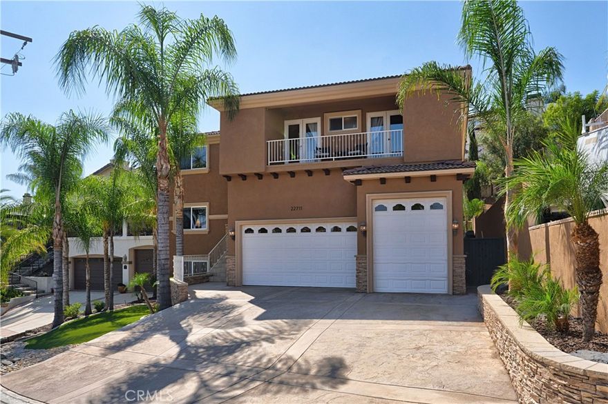 Welcome to this custom Mediterranean tri-level home in the coveted Canyon Lake community. Offering 5 bedrooms—each with its own private bathroom and walk-in closet—this 3,505 sq ft residence is situated on an 8,276 sq ft lot designed for elegance.

From the moment you arrive, the curb appeal captivates with Mediterranean architecture, a 3-car epoxy-finished garage (including RV/golf cart space), lush palms on auto-drip, and astro turf with decorative rock for a true island vibe and low-maintenance lifestyle.

A limestone-trimmed travertine staircase leads you to custom beveled glass double doors. Inside, soaring 19' ceilings and a stunning diamond-pattern travertine foyer welcome you into the grand great room—an open living and kitchen space designed for entertaining. The family room features a wood-burning fireplace, wet bar with wine refrigerator, custom shelving, all flowing seamlessly into a wow-factor chef’s double granite island Kitchen with stainless steel appliances to include: dual Themador ovens, mic., dishwasher, refrigerator, Viking 5 burner range with hood & dual sink. This dream entertaining kitchen is also well equipped with a walk-in pantry, side door to the epoxy-poured 3-car garage, and backyard views.

Step outside to a private retreat with a covered patio, gazebo, a new fountain, shed, and terraced garden spaces framed by astroturf and retaining wall with side yard ladder access to the fruit trees.

The main level primary suite offers peaceful community views, a walk-in closet, and a bathroom with travertine finishes, tub/shower with glass-enclosed walk-in shower. Laundry room features granite counters, a farm sink, and tons of cabinets.

The lower 3rd level game room/6th bedroom features a pool table, granite bar, sink, refrig., and walk-in closet & window with views.

Upstairs, the Romeo & Juliet balcony overlooks the great room. Three additional bedrooms include two with a Jack-and-Jill bath and shared access to an expansive covered balcony. The upstairs primary massive retreat features its own balcony,  spa-like bath with soaking tub, walk-in shower, dual vanities, and a custom closet organizer. Located within Canyon Lake’s 24-hour guarded gate community, you’ll enjoy resort-style amenities including a private 525-acre lake, an 18-hole SCGA-rated golf course with Restaurant, lakefront pool & clubhouse with banquet facilities, RV park, equestrian center, tennis, pickleball, beaches, 14 parks, happy camp, boat docks & more