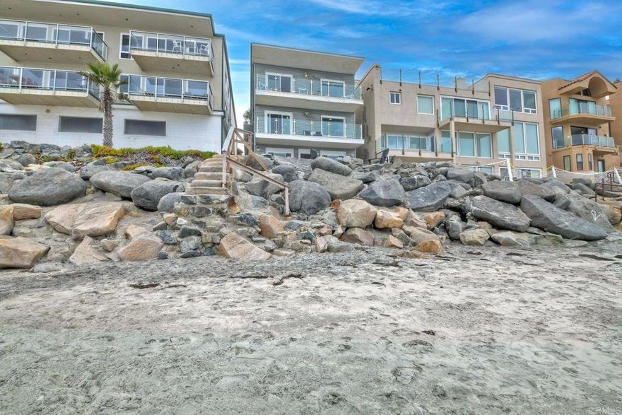 EXCLUSIVE BEACHFRONT HOME IN OCEANSIDE w/ STR OPTION SELLER FINANCING AVAILABLE W/30% DOWN, 4% INTEREST ONLY  Why dream of ocean views when you can live directly on the sand? This rare oceanfront single-family home in San Diego County offers an unmatched coastal lifestyle. Sellers are open to carrying a first loan, making this 8-bedroom (plus optional office/9th bedroom), 4.5-bath gem a unique opportunity.    Main Level: Features a spacious galley kitchen, dining area, great room, 2 bathrooms, laundry room, bedroom, and ocean-view deck.    Upper Level: Includes 4 bedrooms, a laundry closet, an office, and a stunning primary suite with a fireplace, private deck, and large windows/sliders framing spectacular Pacific Ocean vistas.    Beach Level: Offers 3 bedrooms, a full bath, a beach bar with sink and wine fridge, secondary efficiency kitchen, a fireplace, and a vast entertainment area. Step out to a deck with built-in seating, a surf shower, a fire pit, and your own private beach with exclusive ocean-access stairs.  Lock out feature between the first and second floors, creates a rental income opportunity. Bright and airy with abundant storage and 400 sq.ft. of oceanfront deck space. Includes a single-car garage, carport, and off-street parking. Furniture negotiable. No HOA or special assessments. Conveniently near shopping and dining. Seize this extraordinary chance to own a private beach paradise!