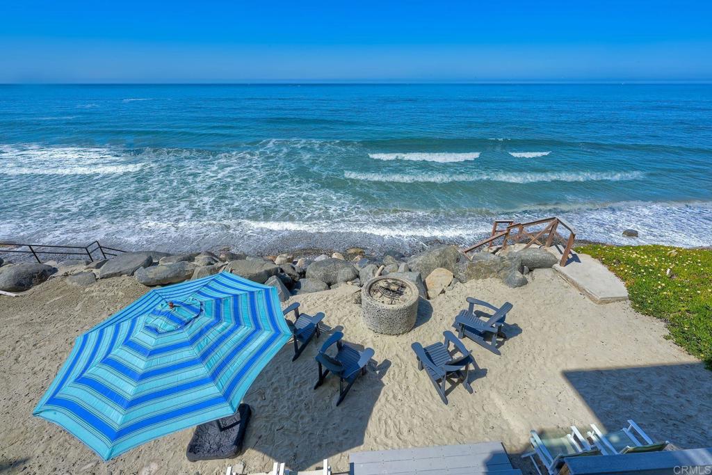 EXCLUSIVE BEACHFRONT HOME IN OCEANSIDE Why dream of ocean views when you can live directly on the sand? This rare oceanfront single-family home in San Diego County offers an unmatched coastal lifestyle. Sellers are open to carrying a first loan, making this 8-bedroom (plus optional office/9th bedroom), 4.5-bath gem a unique opportunity. Main Level: Features a spacious galley kitchen, dining area, great room, 2 bathrooms, laundry room, bedroom, and ocean-view deck. Upper Level: Includes 4 bedrooms, a laundry closet, an office, and a stunning primary suite with a fireplace, private deck, and large windows/sliders framing spectacular Pacific Ocean vistas. Beach Level: Offers 3 bedrooms, a full bath, a beach bar with sink and wine fridge, secondary efficiency kitchen, a fireplace, and a vast entertainment area. Step out to a deck with built-in seating, a surf shower, a fire pit, and your own private beach with exclusive ocean-access stairs. Lock out feature between the first and second floors, creates a rental income opportunity. Bright and airy with abundant storage and 400 sq.ft. of oceanfront deck space. Includes a single-car garage, carport, and off-street parking. Furniture negotiable. No HOA or special assessments. Conveniently near shopping and dining. Seize this extraordinary chance to own a private beach paradise! PROFESSIONAL PICTURES AND VIDEO TO FOLLOW.