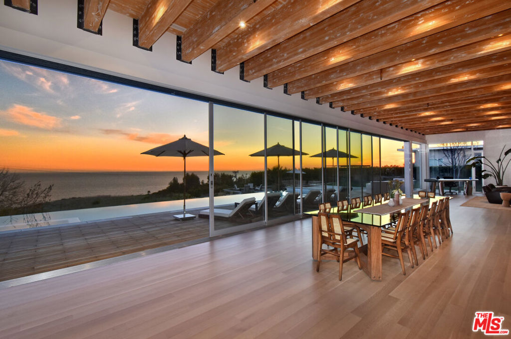 A private sanctuary - this home is architecture as art, featuring priceless panoramic ocean views and sunsets over the coastline. Located just minutes to all that Malibu has to offer - Malibu Country Mart, Nobu, Soho House and more. This home showcases 13' ceilings, open living, and walls of glass leading out to the 60' long infinity edge pool. Features include Fleetwood windows, exposed wood beam ceilings, white oak floors, and a custom Bulthaup kitchen designed for any entertainers dream. The 3 ensuite bedrooms, and primary suite look out over the pool and into the Pacific Ocean. Situated on almost 2 acres, with a 3-car garage and private gate, experience a Malibu lifestyle that is nothing short of extraordinary.