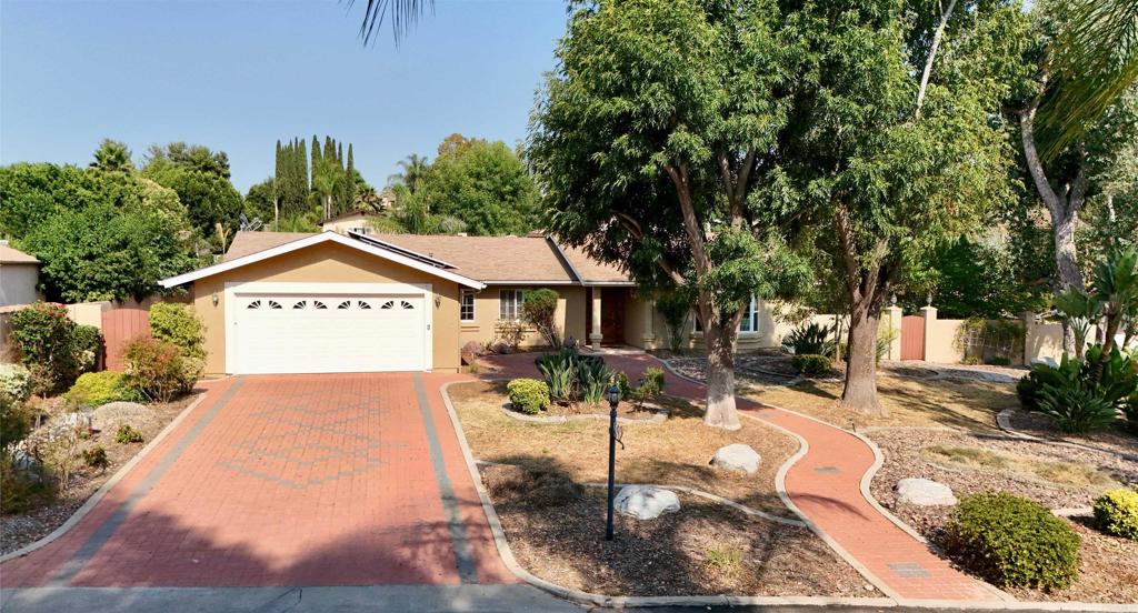 Storybook Charm meets everyday comfort in So. Escondido. Tucked away on a peaceful, private road, this inviting one-story home feels like a warm hug—with spacious living, thoughtful upgrades, and a backyard perfect for making memories. Enjoy 4 bedrooms, one thoughtfully designed as a home office & sewing room, 2 nicely sized bathrooms, and a bonus retreat off the primary suite, there's room for everyone to live, work, and play. Step into a light and bright interior where cozy living meets thoughtful updates. The heart of the home—the kitchen—features a double oven, ample cabinet space, and a generous-sized pantry, making it a dream for any home chef. Unwind with a book in the bay window, or enjoy the cozy ambiance of not one, but two fireplaces. The primary suite is a true retreat with a walk-in closet and a spa-like bath complete with a jetted tub—perfect for relaxing after a long day. Just off the primary bedroom, is a versatile bonus room, perfect for a workout room, reading nook, relaxing escape, or anything your lifestyle calls for. Step outside to your private backyard oasis, ideal for entertaining with a welcoming patio, fruit trees, and natural landscaping that offers a calm, inviting backdrop. Extra perks include: *Owned solar* Tankless water heater* Solar tubes for added natural light* Water filtration system* Alarm system* Garage: Epoxy-finished floor and several storage cabinets* Brick paver driveway *No HOA. Located minutes from schools, shopping, dining, and freeway access—this home has everything you’ve been looking for. Don’t miss the opportunity to own this South Escondido treasure.