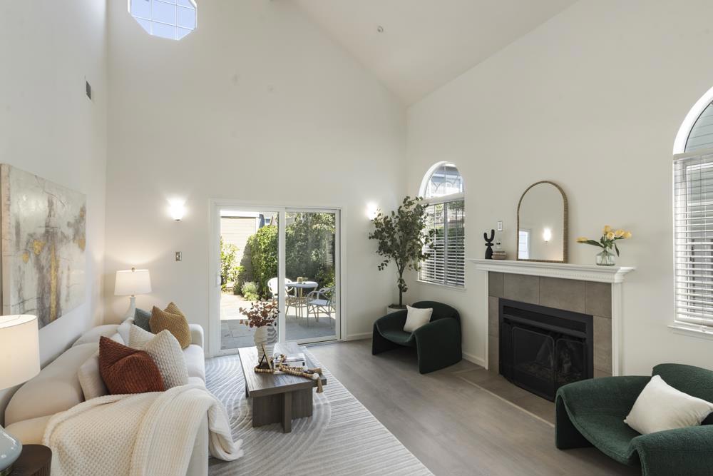 Tucked at the end of a peaceful cul-de-sac, this beautifully updated Williams Landing home blends light-filled comfort with flexible living and thoughtful upgrades. Step inside to soaring ceilings, arched windows, and a gas fireplace anchoring the living room. A sliding glass door leads to a dedicated patio surrounded by lush plantings. An adjacent room with a bay window and a double-drum pendant overhead offers a flexible space for dining, work, or play. The spacious kitchen offers ample quartz countertop space, task lighting, stainless steel appliances including a 5-burner gas range with hood, and a stylish glass tile backsplash. A casual eat-in area with a partially vaulted ceiling includes display-ready cabinetry, a wine fridge, and access to the patio for seamless indoor-outdoor flow. Upstairs, the vaulted-ceiling primary suite is a serene retreat with leafy views, two closets, and an ensuite bath featuring a quartz double vanity and spa-like shower. Two additional bedrooms share a full hall bath. An attached 2-car garage includes built-in storage, laundry, and epoxy flooring. Enjoy resort-style amenities including a pool, hot tub, gym, clubhouse, and tennis courts, connected to the Bay Trail, and nearby parks, top schools, shopping, and commuter routes.