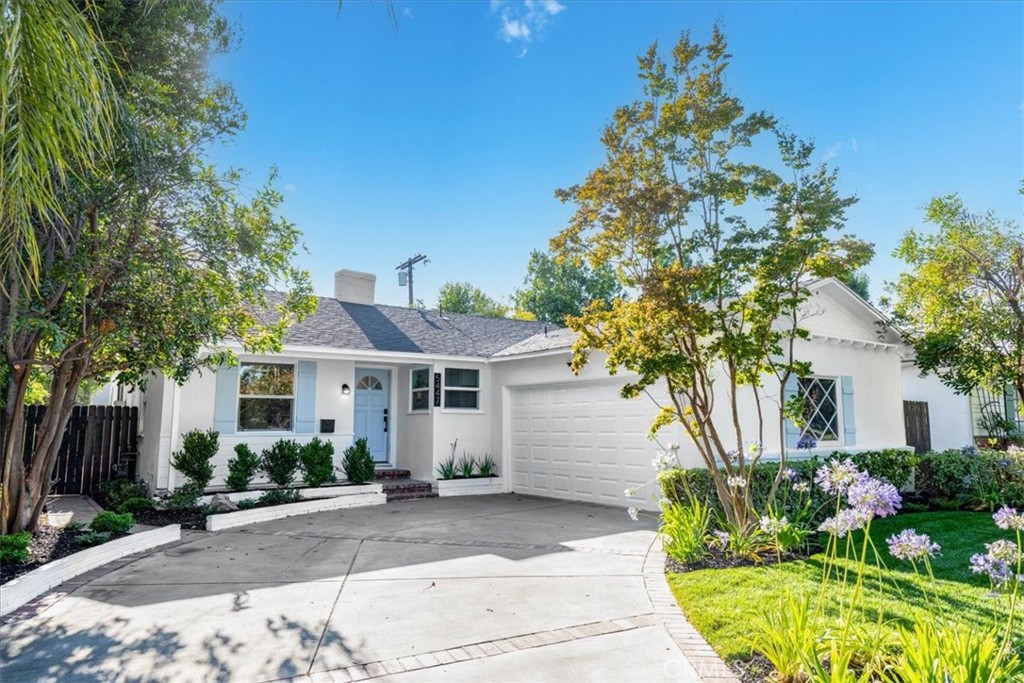 Tucked away on a charming, picturesque tree-lined street in a highly sought-after neighborhood of Sherman Oaks with award winning schools, this meticulously remodeled single-story home offers a perfect blend of modern elegance and serene living. From the moment you step through the front door, you'll be captivated. The design seamlessly integrates a fully equipped kitchen into the bright and airy dining area, and living room accentuated by a tastefully designed floor to ceiling marble tile fireplace. The kitchen boasts top-of-the-line Stainless style appliances, quartz countertops with a breakfast bar, ample soft-closing cabinetry, and a large single basin sink adorned with a striking tile backsplash and floating shelves further enhance the kitchen's appeal. The sliding door off the living room effortlessly merges indoor and outdoor living spaces. Luxurious vinyl wood floors and recessed lighting run throughout the home. The well-appointed primary bedroom features an en-suite bathroom with a free-standing soaking tub and walk-in shower, dual sink vanity and a built-in bench. One of the secondary bedrooms which could be used as an office or den has its own fireplace and elegant French doors that open onto an expansive deck. Step outside to discover a breathtaking backyard designed for both relaxation and entertainment. An oversized wood patio sets the stage for al-fresco dining and gatherings, complete with a fire pit, The property is enveloped in lush greenery, surrounded by mature trees, a spacious lawn area, and serene landscaping, all enhanced by a drip system and sprinklers. Additional features of this home include a new HVAC system with new ducting and a new water heater. The spacious 2-car garage is attached to the home with convenient access into the home. Conveniently located near the highly regarded Kester Elementary School which was recently designated a national Blue Ribbon School, this home also provides easy access to LA's Westside, Beverly Hills, Sherman Oaks Galleria, the serene Japanese garden, boutique shopping, and an array of fine dining options along Ventura Boulevard.