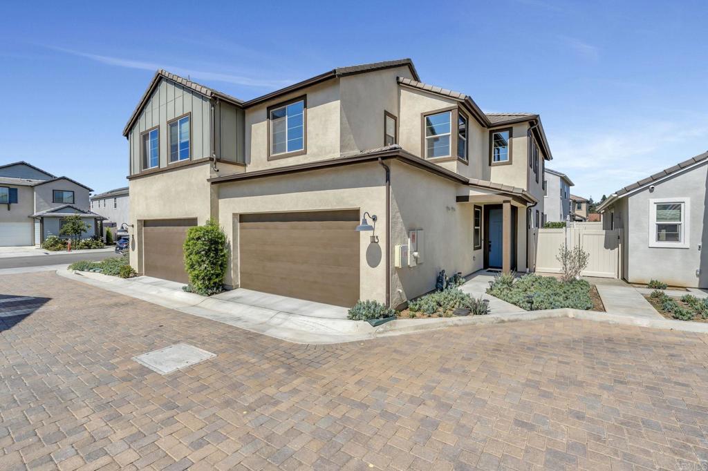 Beautiful “Retreat” neighborhood home located in the newly developed Canopy Grove community. This 4-bedroom, 3-bathroom home offers a thoughtful layout with a first-level bedroom and full bath, upgraded flooring on the first and second levels, owned solar, tankless water heater, and a pavered back yard entertaining space. The entryway opens to high ceilings and leads into the main living space. The kitchen includes an island with seating, custom pendant lighting, tile backsplash, stainless steel appliances, built-in pantry, pull-out trash receptacles, and recessed lighting. The family room is open to the kitchen, creating a spacious and connected living area. Adjacent to the kitchen, the breakfast area includes recessed lighting and a glass door that leads to the backyard. The first-level bedroom is currently being used as an office and includes upgraded flooring and recessed lighting. The first-level bathroom features a glass-enclosed walk-in shower and recessed lights. At the top of the stairs, the landing includes a desk area with seating and lower storage cabinets, along with recessed lighting. The upstairs laundry room includes upper storage cabinets and an open shelf. The primary bedroom has large windows for natural light, recessed lighting, and a ceiling fan. The en-suite bathroom includes white cabinetry, an oversized mirror, a walk-in shower with dual bench seats with a glass enclosure, and a spacious walk-in closet. The additional upstairs bedrooms each include ceiling fans and closets with sliding doors. The backyard features paved areas with ample space for seating and charming patio string lights. The attached two-car garage includes ceiling racks, epoxy flooring, and a tankless water heater. Smart home features in the home include Flo by Moen, water recirculator buttons, Honeywell thermostat, Ring doorbell, Level Lock, My Q Garage, and two eero wifi extenders. Welcome to Canopy Grove, a master-planned community in Escondido offering four unique neighborhoods that blend suburban charm with a vibrant community spirit. This development seamlessly integrates nature and outdoor living with cutting-edge home technologies, making it an ideal place to call home. Canopy Grove boasts an impressive array of amenities, including three beautiful parks, extensive walking paths, two enclosed pickleball courts, playgrounds, a half basketball court, a sand volleyball court, concrete ping pong tables, fresh drinking water stations, barbecues, dog parks, and picnic pavilions. The recreation center features a swimming pool, spa, fitness center, event lawn, and shower facilities. The barn-style recreation area serves as a lively hub for community activities and is available to the public. This space includes a gathering area with a kitchen, indoor and outdoor event spaces, a horseshoe area, restrooms, and an office, making it perfect for social events and community gatherings. Homes at Canopy Grove were originally designed with modern living in mind, featuring stainless steel appliances, quartz kitchen countertops, integrated home automation, and whole-home connectivity technology. Conveniently located just minutes from Interstate 15 and California State Highway 78, Canopy Grove offers easy access to all that Escondido has to offer.