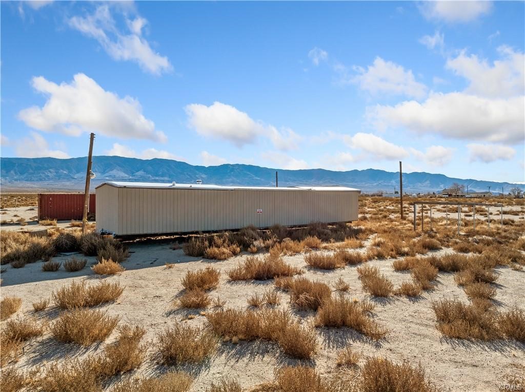 Beautiful 20 Acres Flat land in Agriculturally Zoned , This unique property is Very close to the pavement and located very close to the main US HWY 18, offering convenient access to many parts of the city. With breathtaking landscapes, panoramic views, expansive space and huge even lot, this property offers endless opportunities to anyone looking to build their dream home and start their own personal side projects. Looking for an adventure? Big Bear Lake and Joshua Tree National Park is not too far of a drive away! Land is graded, corners are marked, and entrance to the property is less than a quarter-mile away from paved roads. This property has a fully functioning well (~4 Years Old) and has utility poles already installed on the property for easy connection to the main grid. The Manufactured Home needs TLC ..Call for additional information