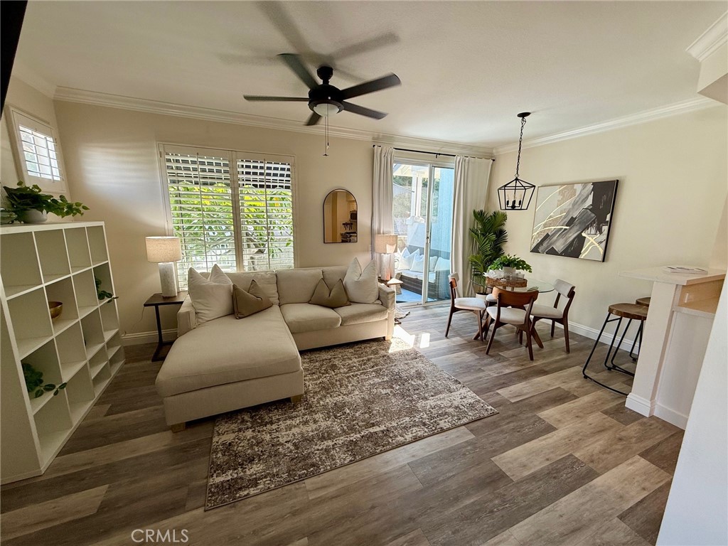This beautifully updated end-unit in the sought-after Coronado Cay community of Aliso Viejo is the definition of move-in ready. Since ownership, the home has been extensively improved with LVP flooring throughout, crown molding, updated baseboards, new interior doors, fresh designer paint, new lighting fixtures, and a Nest thermostat for modern comfort. The kitchen shines with quartz countertops, sleek cabinet hardware, and stainless steel appliances—perfect for both everyday living and entertaining. The open floor plan offers a light-filled living area and a dining space that flows effortlessly to a private patio, ideal for enjoying morning coffee, weekend barbecues, or hosting friends and family. A convenient half guest bathroom is also located on the main level. Upstairs, two spacious dual en-suite bedrooms each feature their own updated baths. The primary suite includes a dual-sink vanity with quartz countertops, designer fixtures, and a custom-organized walk-in closet. Additional highlights include an upstairs laundry room, a TWO CAR GARAGE WITH DIRECT ACCESS, and newly added garage storage cabinets. The home’s prime end-unit location offers extra privacy, an abundance of natural light, and serene views of lush community landscaping. Residents enjoy access to the community pool and well-maintained common areas, as well as the convenience of being just minutes from Aliso Viejo Town Center, award-winning schools, hiking and biking trails, golf courses, and nearby beaches. With its ideal combination of style, location, and amenities, this home is ready for its next owner to enjoy.