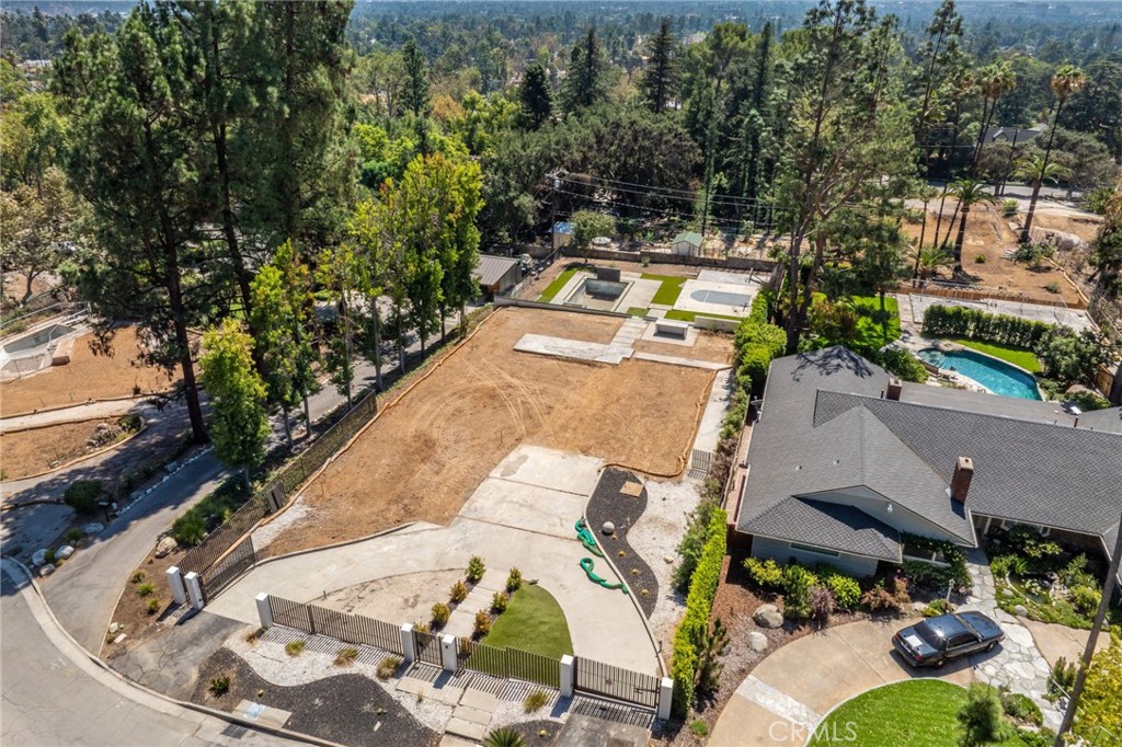 Beautiful vacant lot in Altadena – prime opportunity to rebuild or build your dream home. Approved plans included!
Discover a rare and exciting opportunity to create your dream estate in a prime location in Altadena. This expansive flat 20,000+ sq ft estate lot, nestled at the end of a quiet cul-de-sac, once housed a 4,200 sq ft., 5 bedroom 5 bathroom beautiful home lost in the Eaton Fire—but the resort-style amenities remain intact.
Enjoy the luxury of existing hardscaping, artificial turf, landscaping, gated circular driveway, built-in outdoor kitchen/BBQ, private sports court (basketball/pickleball), and a pool & spa—all just less than two years old. These existing amenities alone will save you hundreds of thousands of dollars on the rebuild. The lot is fully equipped with a newer septic system, and all utilities (water, electricity, and gas) were in place prior to the fire.
Located in close proximity from the Altadena Town & Country Club, this lot comes with fully approved architectural plans—a $100,000 value—saving you time and money on your rebuild. Imagine a modern architectural masterpiece with walls of glass, open-concept living, and seamless indoor-outdoor flow—all designed to showcase breathtaking mountain views.
Key Features:
Over 20,000 sq ft flat estate lot
Approved architectural plans included
Existing pool & spa, outdoor bar, sports court (Basketball and Pickleball)
Artificial turf, landscaping, gated circular driveway & hardscaping
Septic system in place (2 years old)
All prior utilities available: water, gas, electricity, sewer
Debris removal completed (Army Corps Phase 1 & 2)
Located in a peaceful cul-de-sac near Altadena Country Club
Whether you're building your forever home or developing an investment property, this property offers a blank canvas in a coveted Altadena neighborhood. With approved plans and premium amenities already in place, you can move forward with confidence and vision.
Buyer to verify development potential, zoning, lot size, utilities, and permitting with Los Angeles County.
