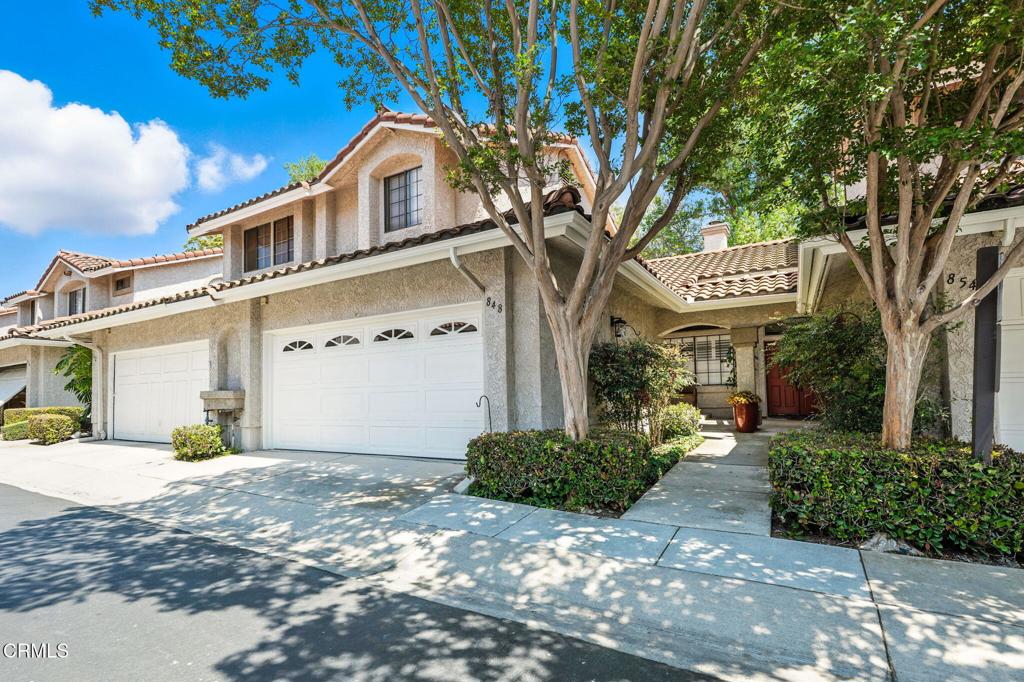 Own a piece of SoCal paradise within the gated community of Camarillo Springs! Many upgrades adorn this beautiful Townhouse with a floorpan that flows through the first level and fills the second level with two ensuite bedrooms with immense closet space. From the foyer, enter the spacious living room with a soaring vaulted ceiling, 3/4 split window shutters, and cozy up to the fireplace w/custom fireplace screen. Enjoy culinary delights from the delightfully remodeled kitchen with gorgeous hardwood kitchen cabinetry w/roll outs and under counter lighting, and no need to buy a refrigerator, the stainless steel refrigerator with water and ice dispenser in the door is included! Savor the flavor from the breakfast bar and dining area filled with natural light from 3 windows that wrap around the back wall. Adjacent to the living room, step out onto the patio, which has dual access from both the dining area and living room, and enjoy a morning coffee, an afternoon ice tea, a family and friends BBQ, or the stars in the night sky. The large primary bedroom features a fabulously remodeled, roomy shower. Other upgrades adding to the color palate and decor are durable, laminated distressed hardwood throughout the first floor, freshly installed carpet in bedrooms, upstairs hallway and stairs, baseboards, door casings, crown moulding, Decora switches and receptacles and water heater. Further upgrades include newer toilets in all bathrooms for water savings, raised panel doors with lever handles, and whisper quiet garage door opener. Storage is made easy with ample linen cabinet storage and a substantial hallway closet downstairs. Keep your vehicle(s) out of the elements in the attached two car garage. For your guests, parking is a short distance away. Community amenities are right around the corner with pool, spa, club house and BBQ area. A truly desirable location with mountain views, close to dining and businesses, Camarillo Springs Golf Course, and freeway access. Don't miss your opportunity to own one of the most bang for your buck townhomes in Camarillo!