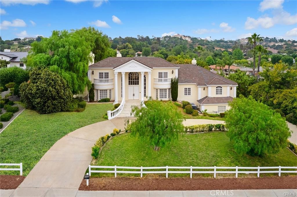 Discover a true gem in Diamond Bar's "Country Estates"—a luxurious residence on a rare, expansive flat lot. This beautifully maintained home boasts a grand circular driveway, elegant marbled flooring, soaring ceilings, and stunning Roman columns. Enjoy a spacious main-floor master suite with a lavish bathroom, dual vanities, walk-in closet, and backyard access.
The gourmet kitchen, with built-ins and a cozy breakfast nook, opens to a sophisticated formal dining area. Upstairs, a modern den leads to a large viewing deck, perfect for relaxing with scenic views.
The backyard is a private paradise, featuring a sparkling pool and spa, built-in BBQ, lush garden, private tennis court, gazebo, and ample grassy areas. With classic elegance, modern amenities, and ample space, this property is ideal for luxurious living and entertaining. Don’t miss the chance to own this "Country Estates" masterpiece!