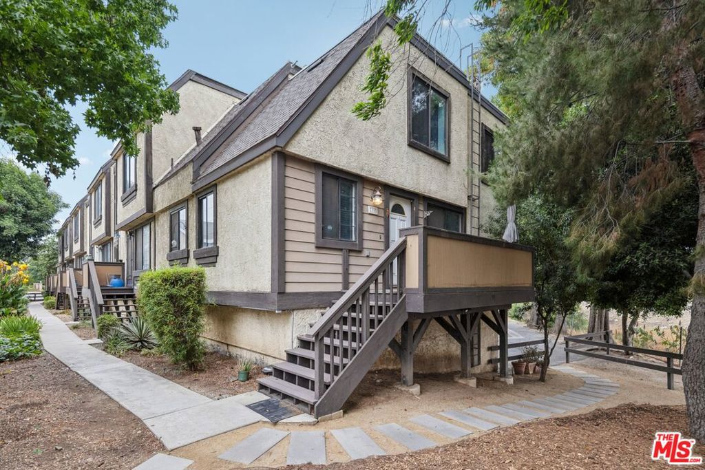 Stylish Tri-Level Townhome in Gated Community! Welcome to 11300 Foothill Blvd #30 a beautifully updated 3-bedroom, 2-bath townhome tucked inside the desirable Shadow Mountain Trails community in Lakeview Terrace. This light-filled home features soaring ceilings, designer finishes, and a layout that perfectly balances comfort and style.Step inside to a spacious living room with vaulted ceilings, rich wood-look floors, and a cozy fireplace that opens to your own private patio ideal for morning coffee or evening wine. The remodeled kitchen boasts granite countertops, stainless steel appliances, and a breakfast bar overlooking the dining area, perfect for hosting.Upstairs, unwind in the oversized primary suite with vaulted ceilings and generous closet space. Two additional bedrooms offer flexibility for a home office, guest room, or growing family.Enjoy the convenience of direct access to your 2-car garage, in-unit laundry, central A/C & heat, and tons of storage space throughout.Community perks? Gated entry, sparkling pool & spa, lush landscaping, and ample guest parking. Located just minutes from hiking trails, Hansen Dam Recreation Center, and easy access to the 210 freeway this home is a rare blend of peaceful living and commuter-friendly convenience.Turnkey, stylish, and move-in ready don't miss your chance to call this one home!