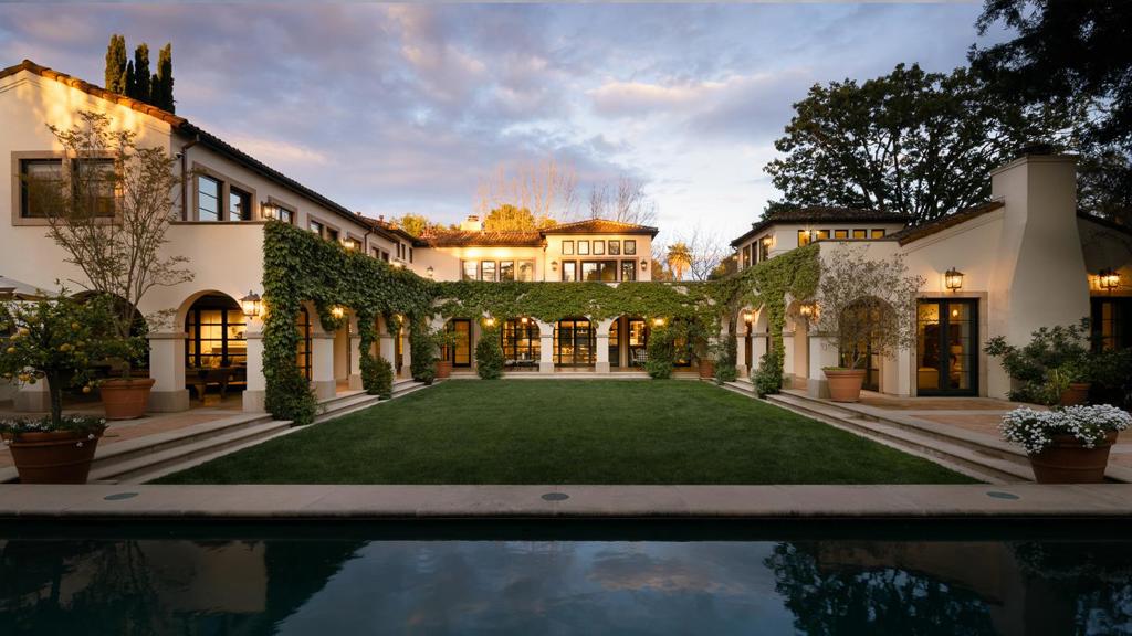 Custom-built in 2001, this home embodies relaxed family living with a seamless indoor/outdoor connection inspired by Santa Barbara's Spanish Revival style. Interiors by renowned designer Suzanne Tucker ensure authenticity from reclaimed ceiling beams to terracotta tile floors and wrought iron fixtures. Custom touches include decorative handmade tiles on stair risers and a quatrefoil motif throughout with laser-cut screens that adorn many clerestory windows for filtered light. The U-shaped design surrounds a vast central courtyard with pool and spa from a covered loggia on 3 sides that supports private balconies for each upstairs bedroom suite. Retractable glass doors in the living room and great room blur the boundaries for indoor/outdoor living. There are 5 bedroom suites including a multi-room main-level suite and upstairs primary suite that shares a terrace with a private office just off the foyer. A recreation room easily accessed from the bedroom wing adjoins a covered outdoor lounge next to the poolside cabana with pizza oven and barbecue kitchen. This home is located in the esteemed Crescent Park neighborhood close to Stanford University and with access to acclaimed Palo Alto schools.