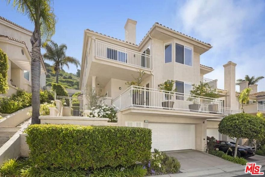 Nestled within the exclusive gated community of Sea Ridge, this beautifully updated 4-bedroom, 3-bathroom townhome sits on the highly coveted mountainside and offers over 2,900 square feet of refined living space. Step inside to find brand-new flooring throughout and an abundance of natural light streaming through large windows, creating a warm and inviting atmosphere.The formal living room, anchored by a cozy fireplace, flows seamlessly into the elegant dining area and adjoining gourmet kitchen. Outfitted with high-end appliances, custom cabinetry, a stylish backsplash, and a charming breakfast nook, the kitchen is both functional and sophisticated.Perfect for entertaining, the spacious family room opens to a private backyard- ideal for barbecues and al fresco dining. The main level also features a balcony off the living room, a guest bedroom, and a full bathroom.A skylight brightens the staircase leading to the upper level, where you'll find the expansive primary suite. This private retreat boasts vaulted ceilings, a sitting area with a fireplace, two large closets, and a private balcony with stunning ocean and mountain views. Upstairs also includes two additional bedrooms, a third full bathroom, a remodeled laundry room, and a convenient office nook.The lower level offers direct access to the garage and an additional bonus room perfect for a gym or home office.Residents of Sea Ridge enjoy the peace of mind of a gated community with access to a sparkling pool and spa. All just minutes from the Caruso Palisades Village, world-class dining and shopping, scenic hiking trails, and the Pacific Ocean.