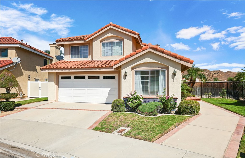 Welcome to the highly sought-after guard-gated community of Green River, where comfort meets convenience in a beautiful hillside setting. Upon entering this 4-bedroom, 3-bath home (with a full bedroom and bath on the main level), you’re welcomed by a spacious living room with soaring vaulted ceilings that create an open and inviting atmosphere. The home sits on one of the larger lots in the community, offering the perfect blend of space, privacy, and resort-style living. Step into the updated open kitchen featuring granite countertops, stainless steel appliances, a center island, and a garden window that fills the space with natural light. The kitchen seamlessly flows into the inviting family room, complete with a cozy fireplace for relaxed gatherings. Separate living and dining rooms provide additional options for entertaining or quiet evenings in. The true highlight of this home is the backyard retreat, a private pool and generous outdoor space designed for relaxation, entertaining, and enjoying the Southern California lifestyle. Whether hosting summer barbecues or unwinding after a long day, this yard is your own personal escape. Upstairs, you’ll find the remaining bedrooms with vaulted ceilings that create a sense of openness and light. The primary suite offers a tranquil retreat with ample walk-in closet space, updated bathroom and serene views of the surrounding mountains. As a resident of Green River, you’ll also enjoy access to an array of amenities including a clubhouse, fitness center, tennis courts, pickle ball, playground, and more. All just minutes from Orange County, with quick freeway access for commuting. Don’t miss the opportunity to own a home that combines a rare oversized lot, a private pool, and the security of a guard-gated community.