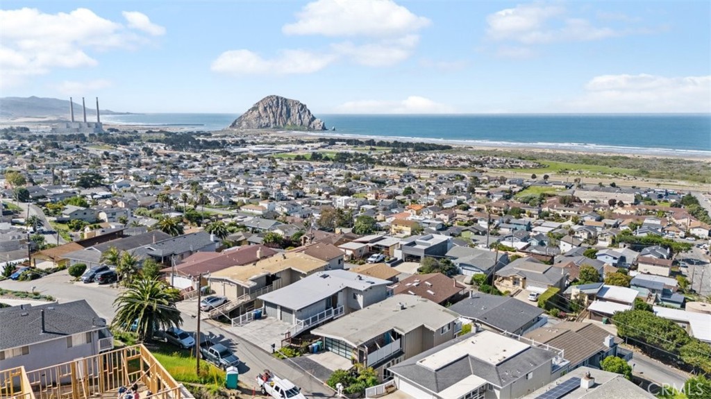 Enjoy sweeping views from Point Estero to Point Buchon—including iconic Morro Rock, the harbor entrance, tranquil back bay, and endless stretches of whitewater ocean. This beautifully maintained 3-bedroom, 2.5-bathroom home offers approximately 1,600 sq. ft. of coastal living at its finest. Step inside to find a remodeled kitchen, a newer membrane roof, and brand-new composite decking with reinforced structural supports—perfect for soaking in sunsets and sea breezes. The main level includes direct access from the two-car garage, along with the primary suite, a cozy fireplace-warmed living room, dining area, and kitchen—ideal for single-level living. Downstairs, you'll find two additional bedrooms, 1.5 bathrooms, a laundry room, and a spacious bonus room with exterior access—perfect for a media room, home office, or guest space. Lovingly cared for and move-in ready, this home is your chance to embrace the beauty, peace, and charm of Morro Bay living.